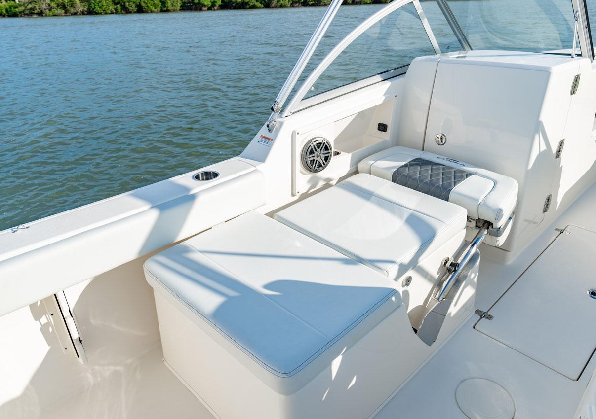 Manufacturer Provided Image: 2025 Cobia 220 Dual Console boat interior with seating and water view.