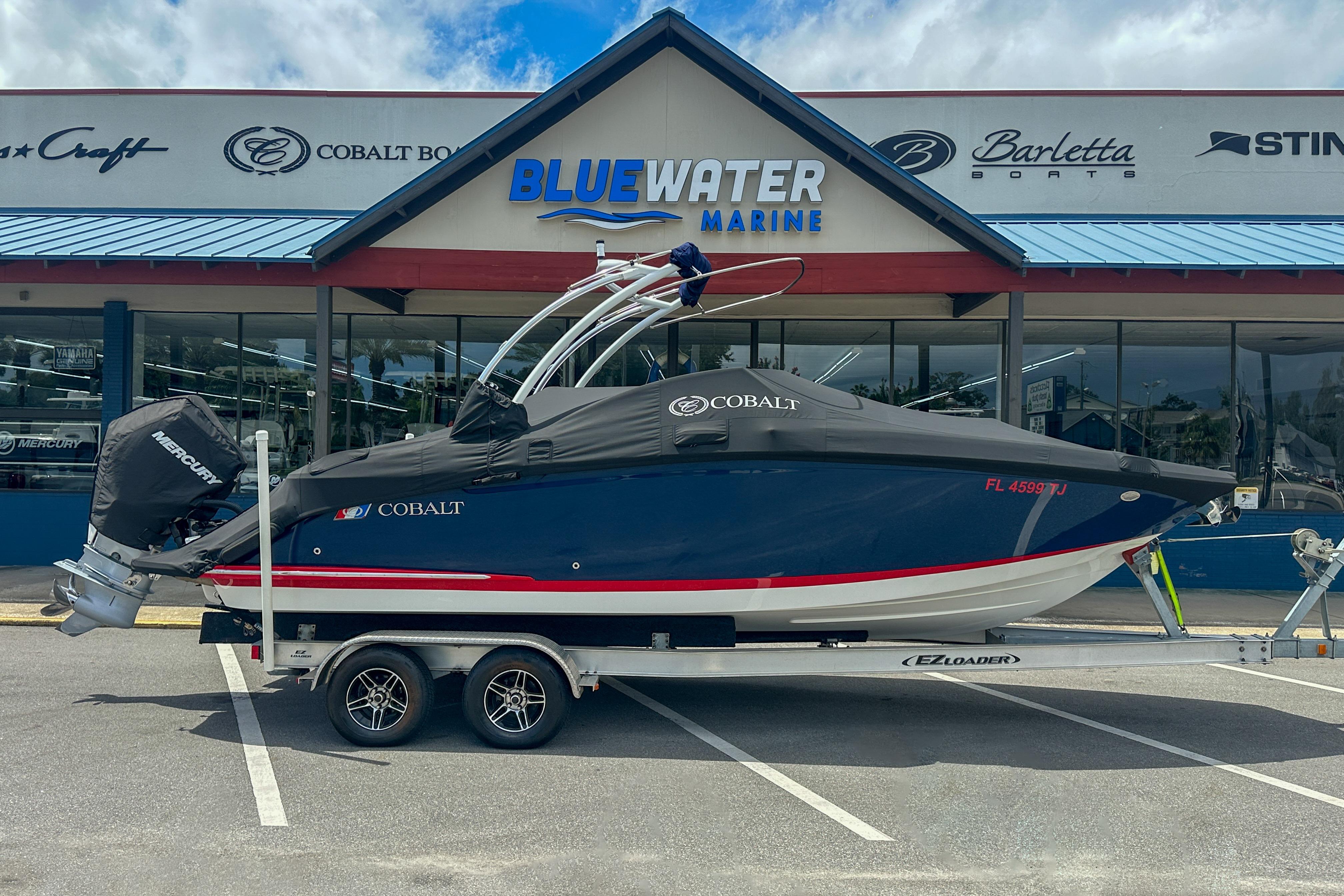 2022 Cobalt 25SC boat on trailer outside Bluewater Marine dealership.