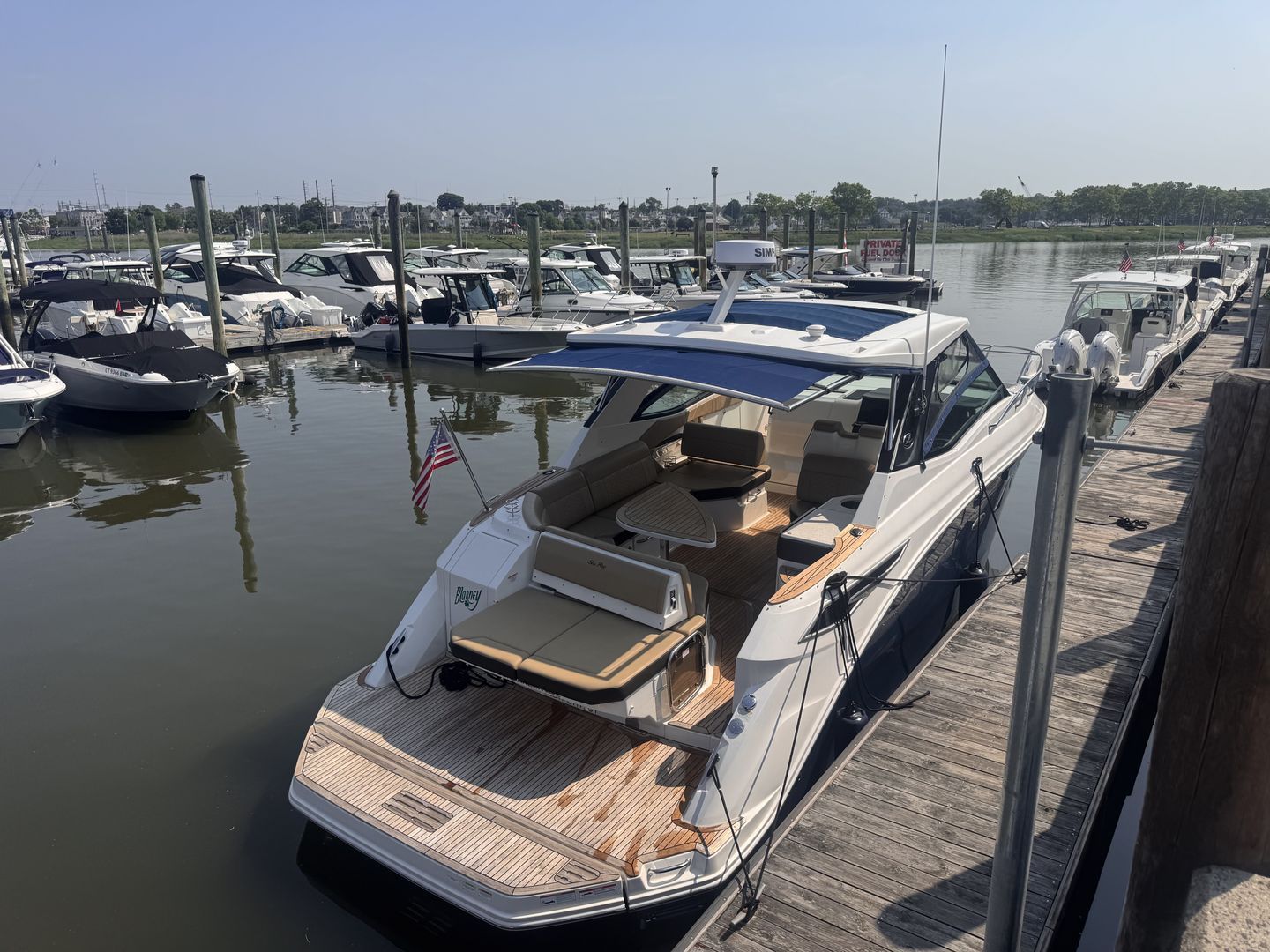 A 2019 Sea Ray Sundancer 320 docked. It features a sleek design with a spacious deck.
