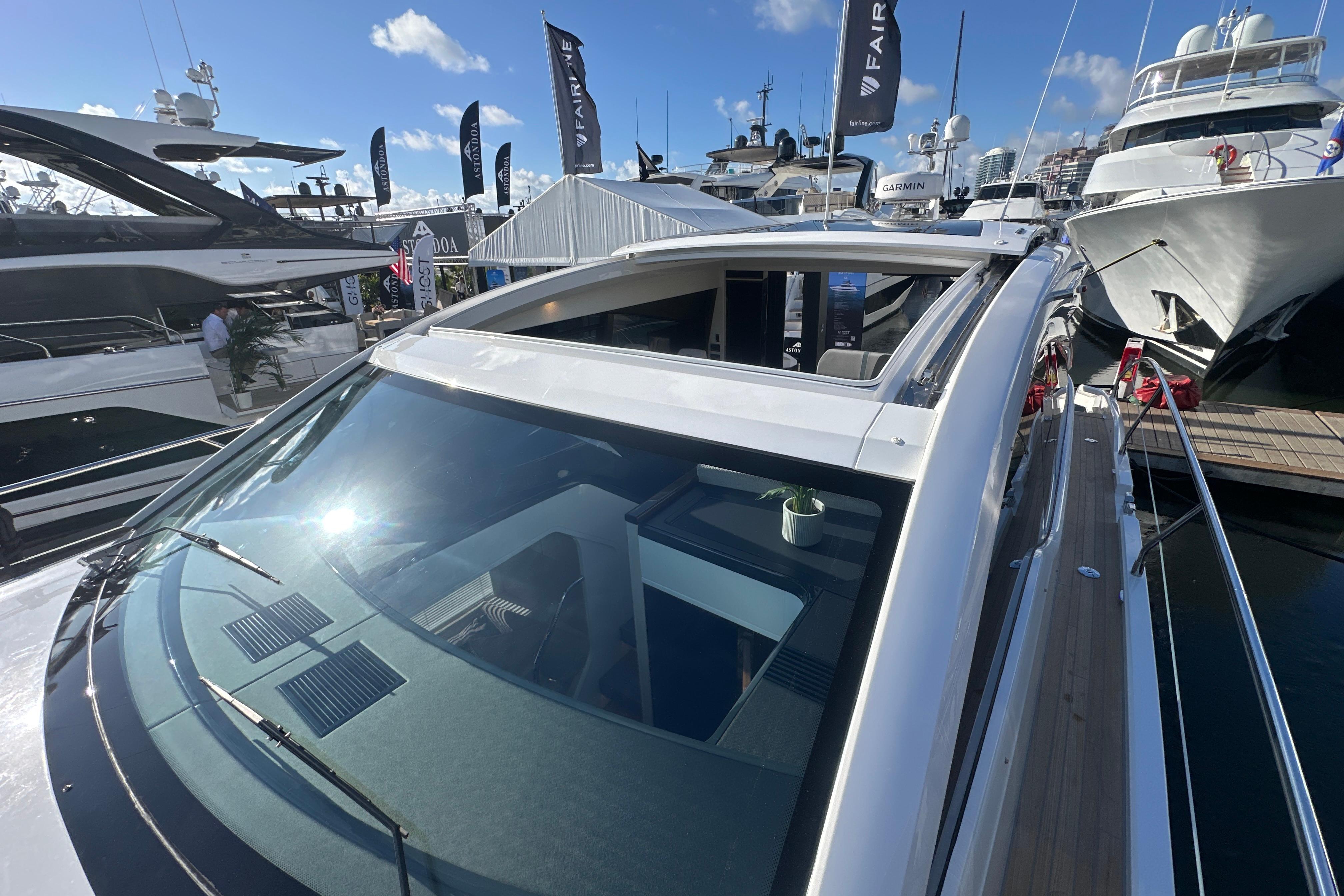 2026 Fairline Targa 47 GT yacht at marina, showcasing sleek design and open sunroof.