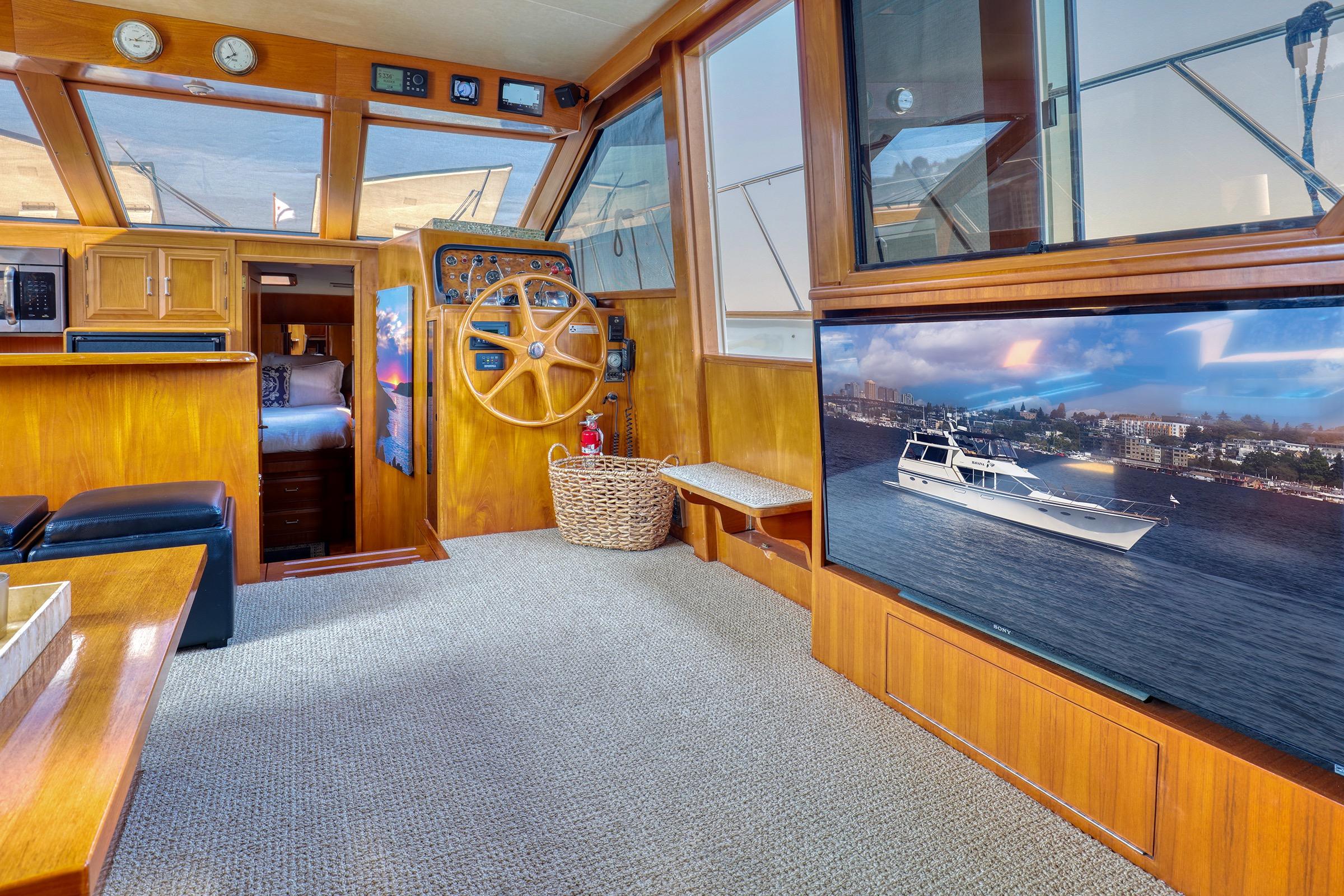 Interior of 1987 Ocean Alexander 480 Sport Sedan with wooden helm and modern amenities.