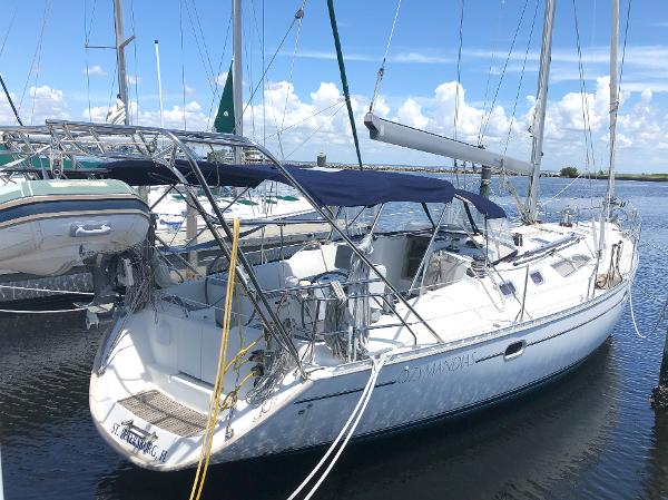 2001 Jeanneau 45.2 sailboat docked in marina under clear blue sky.