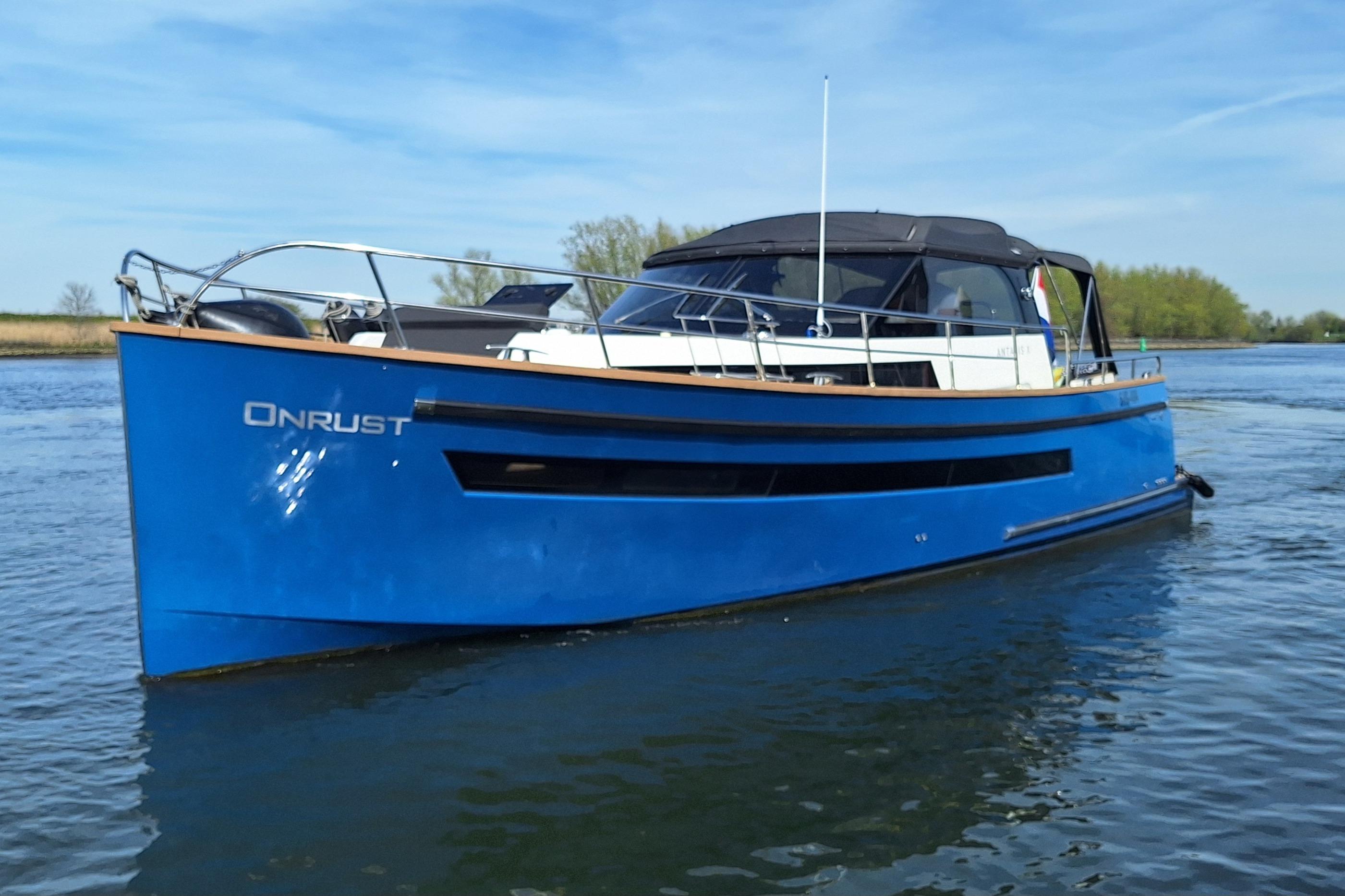 2023 Antaris X boat on water, blue hull, sleek design, sunny day.