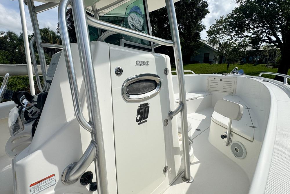 2018 Mako 284 Center Console boat interior with steering console and seating.