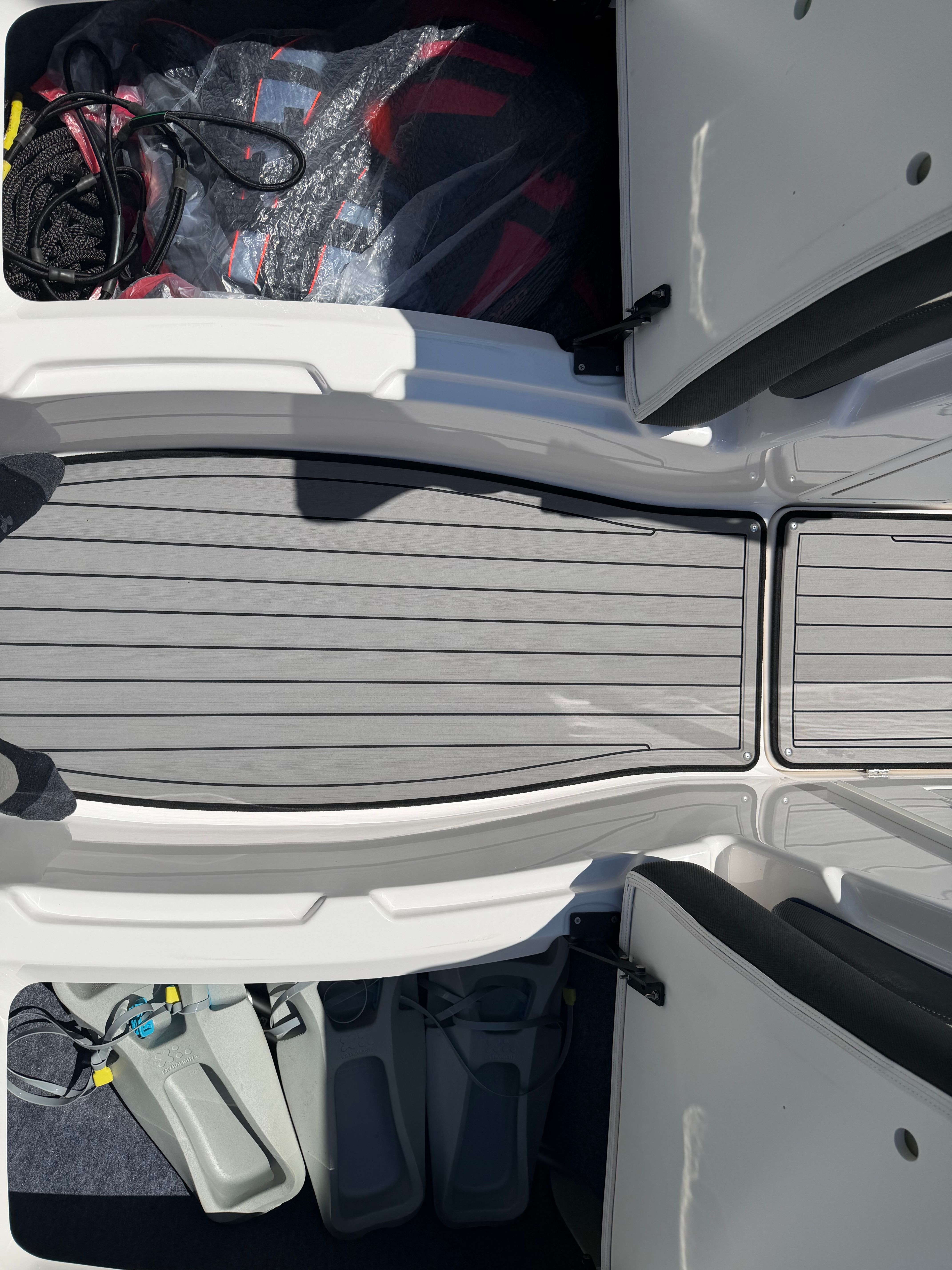The image shows the deck of a Yamaha 242 Limited S boat with storage and accessories.
