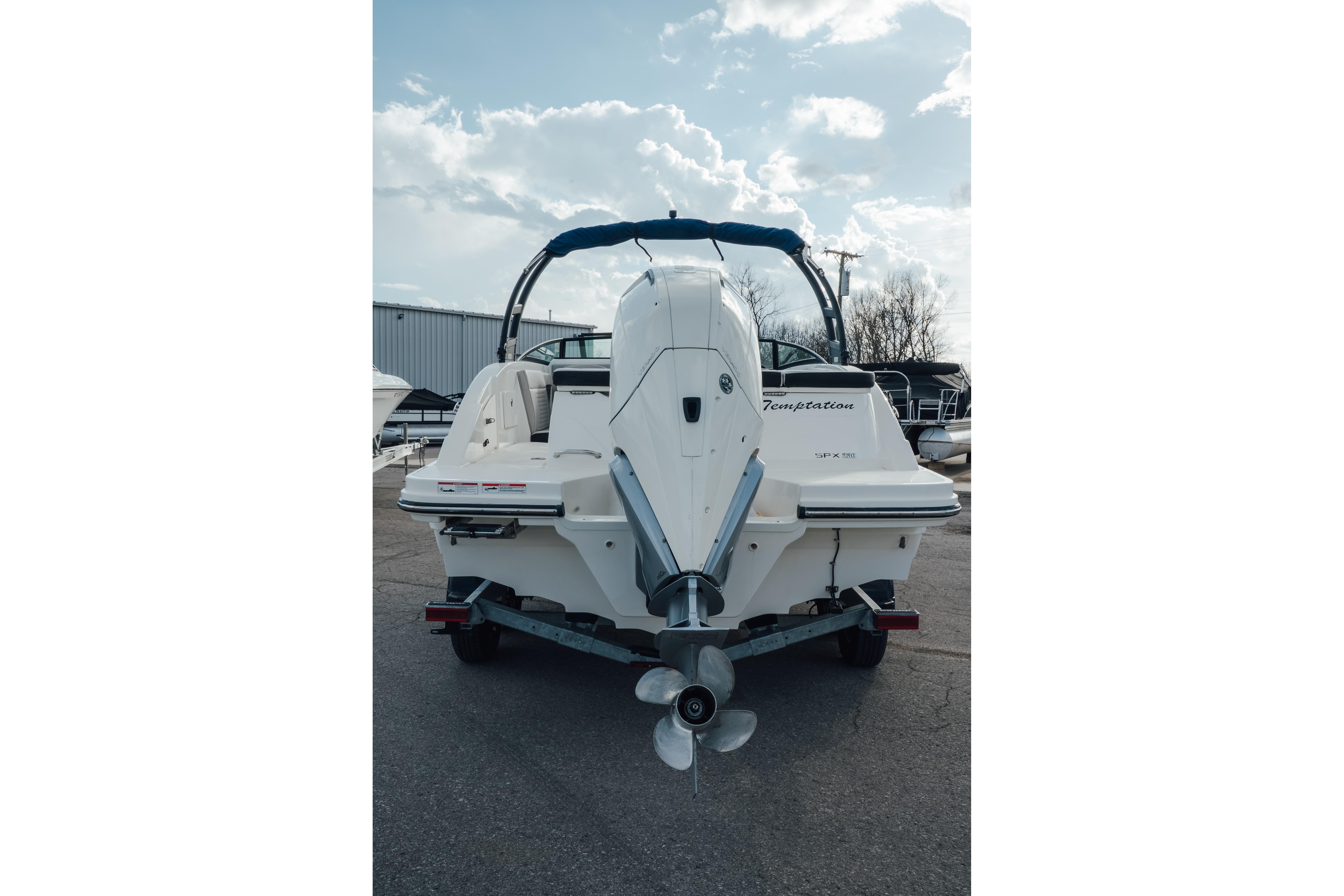 2023 Sea Ray SPX 230 Outboard boat, rear view with outboard motor, parked outdoors.