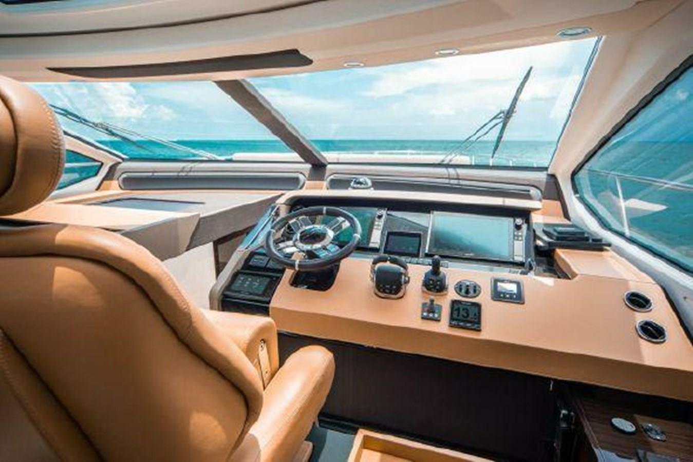 Luxurious helm of a 2019 Azimut 77S yacht with advanced navigation controls.