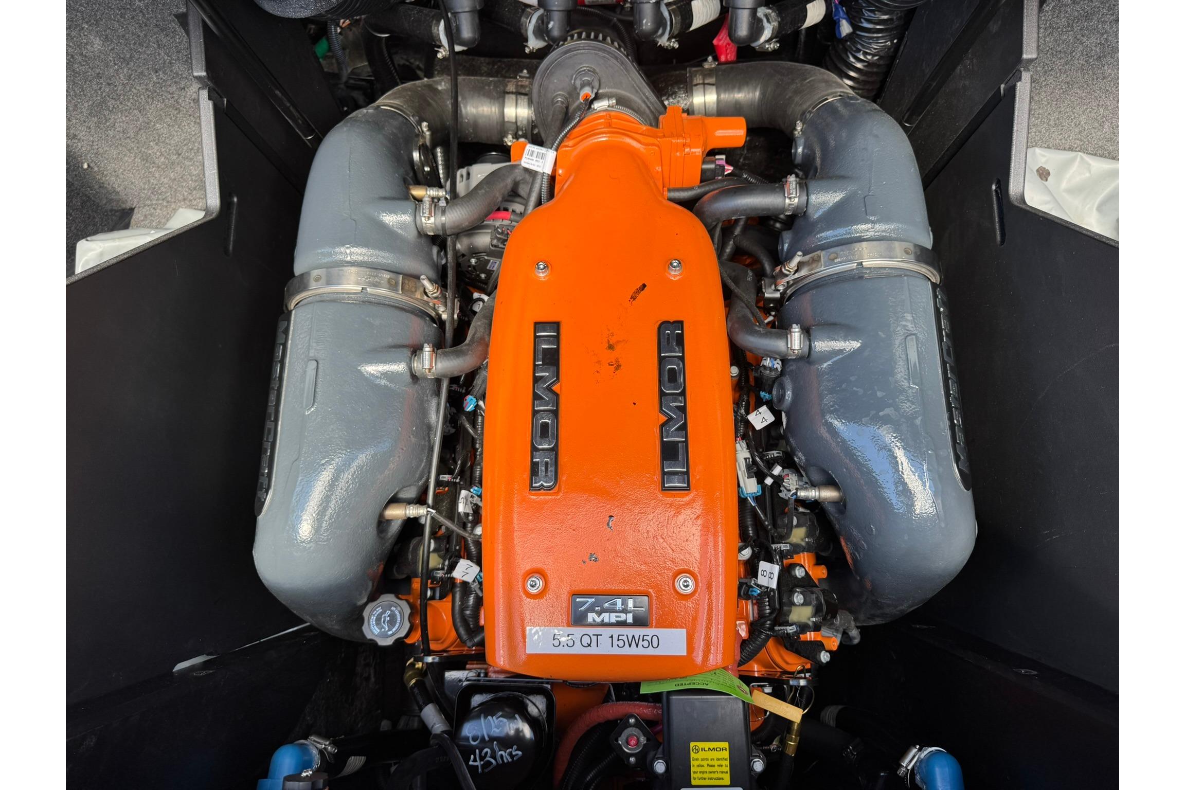 2021 MasterCraft X26 Ilmor engine, vibrant orange cover, detailed view.