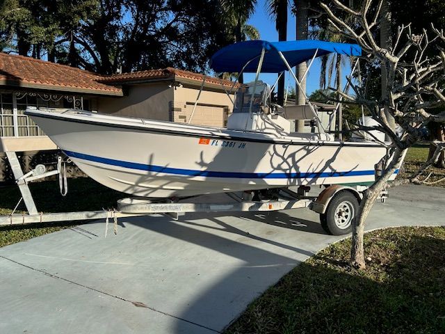 1994 Aquasport Osprey boat on trailer in driveway.