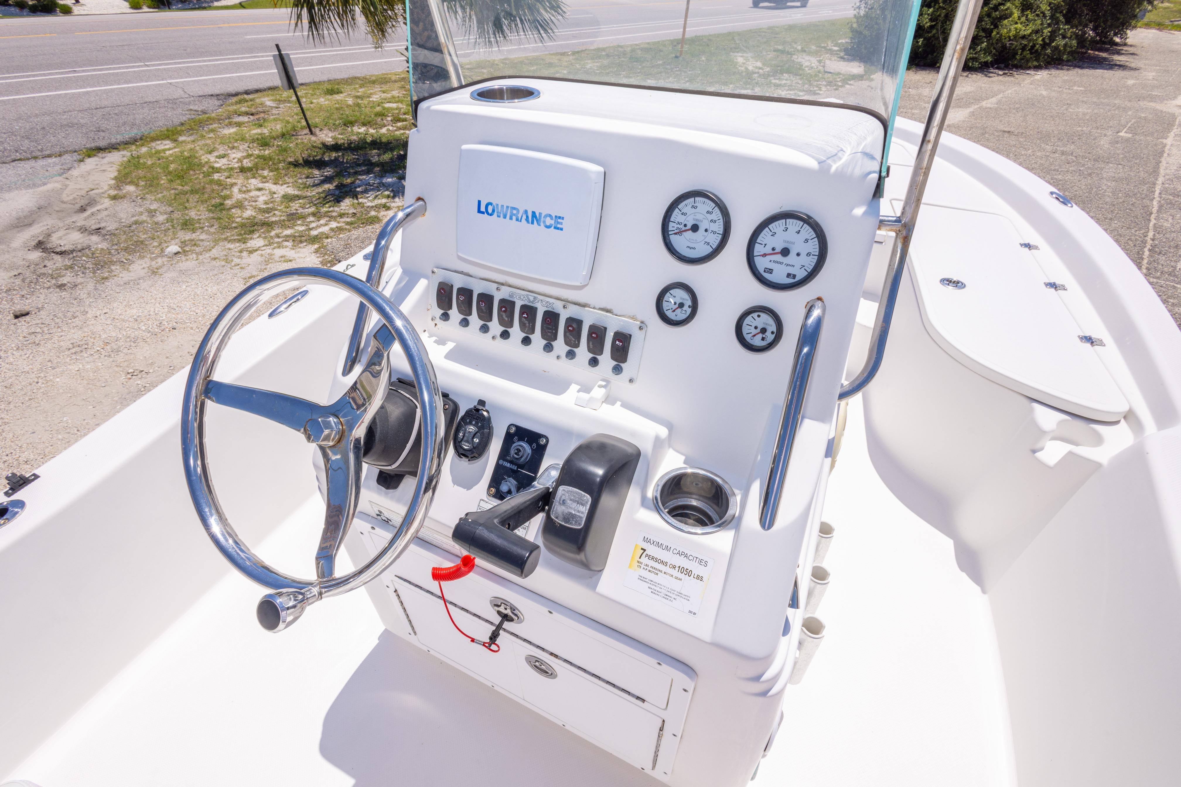 2011 Sea Fox 200XT boat console with steering wheel and gauges, featuring Lowrance electronics.