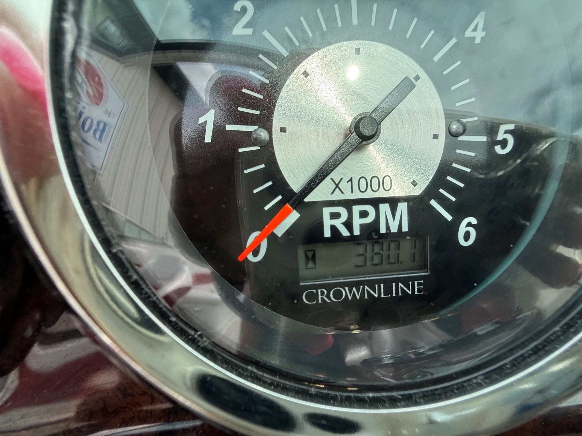 Close-up of a tachometer labeled "Crownline" showing 350.1 hours.