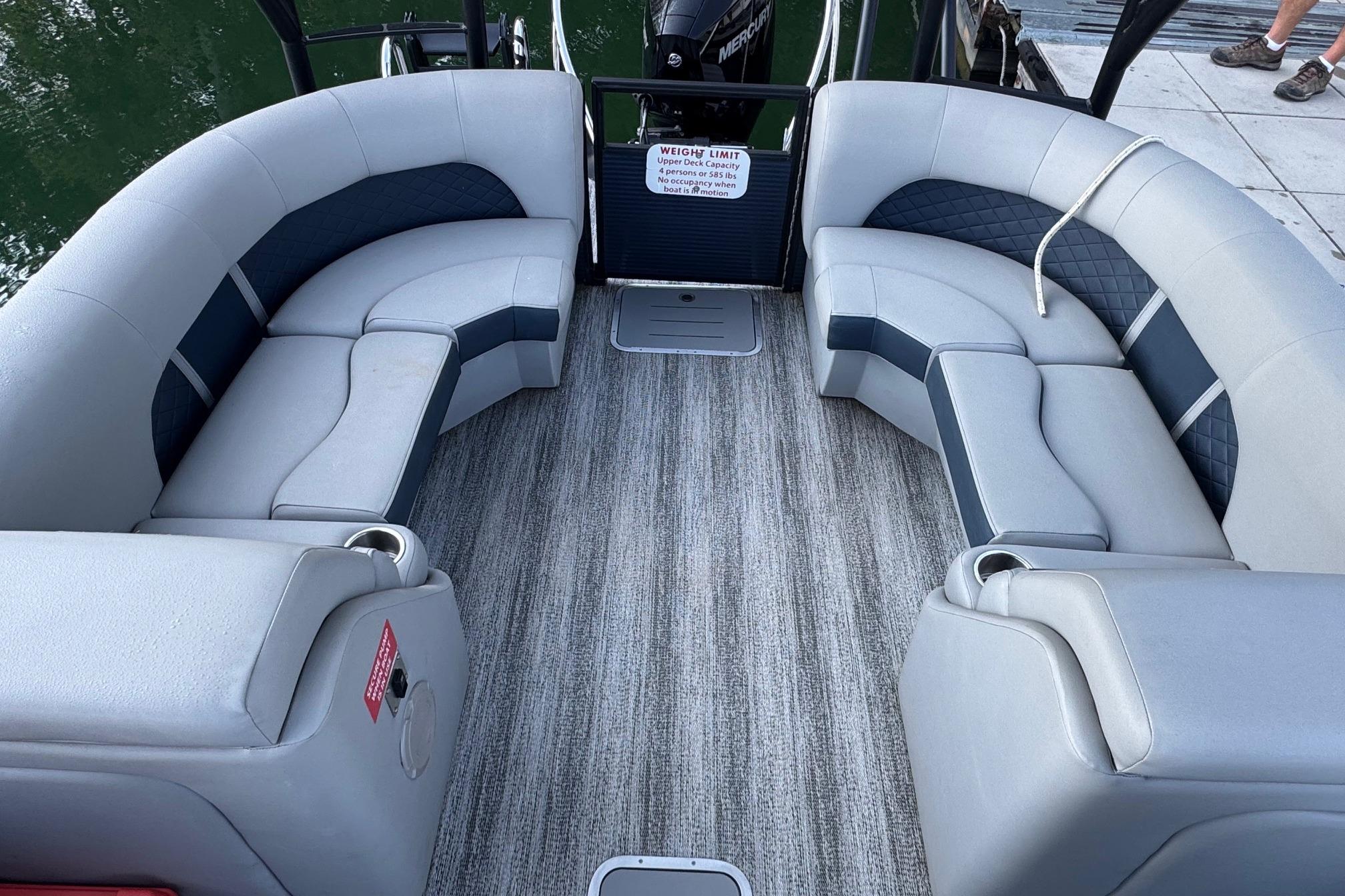 2025 Bennington 26 L Top Deck boat interior with gray seating and carpeted floor.
