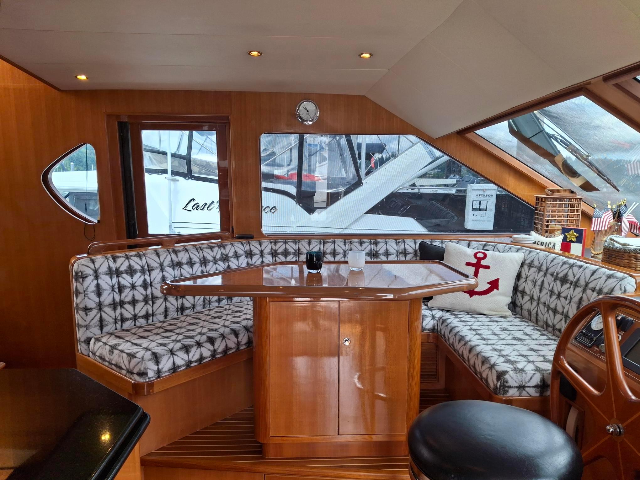 Luxurious interior of 2004 Ocean Alexander 64 Pilothouse yacht with elegant seating and decor.