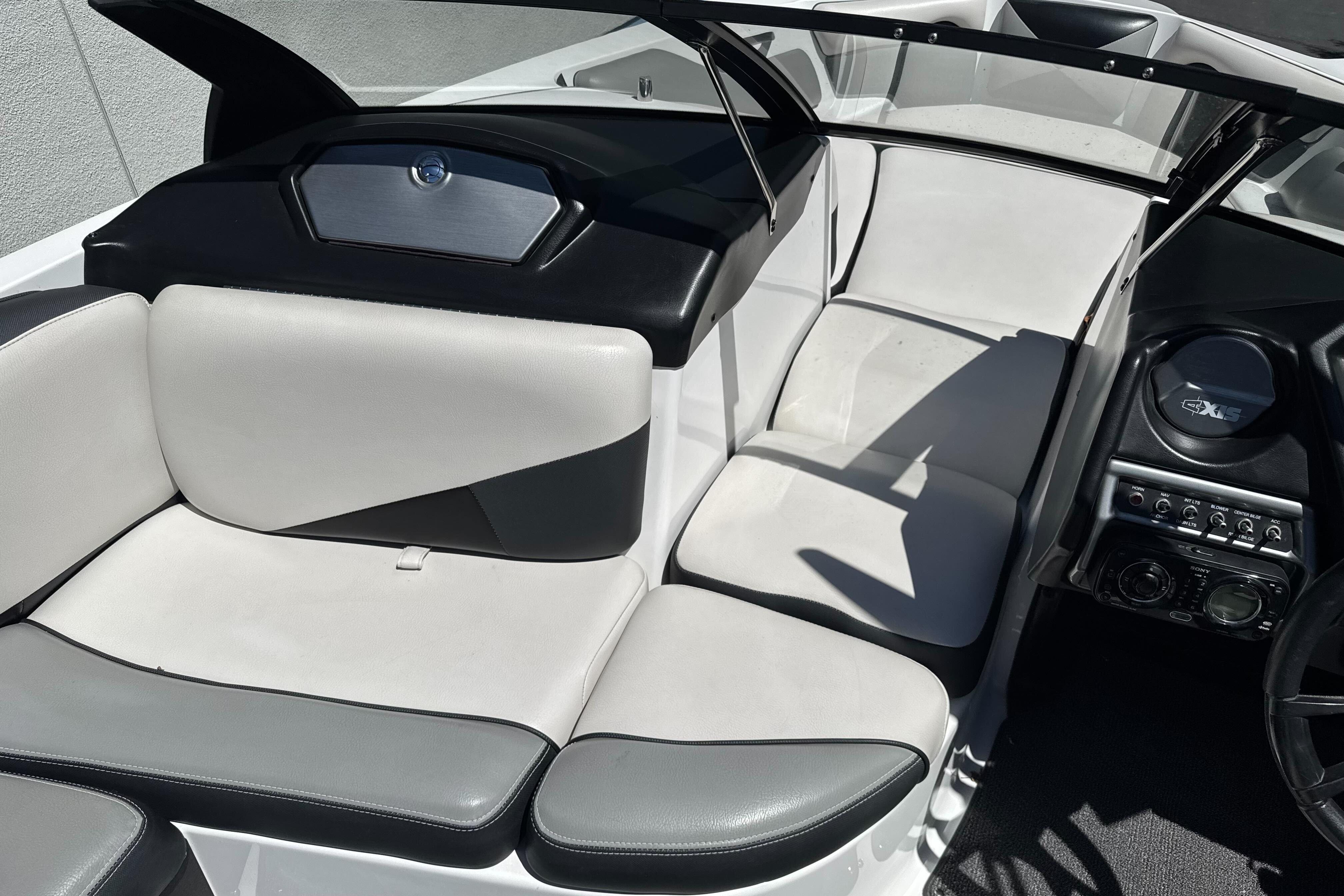 2015 Axis A20 boat interior with white and black seating, dashboard, and controls.