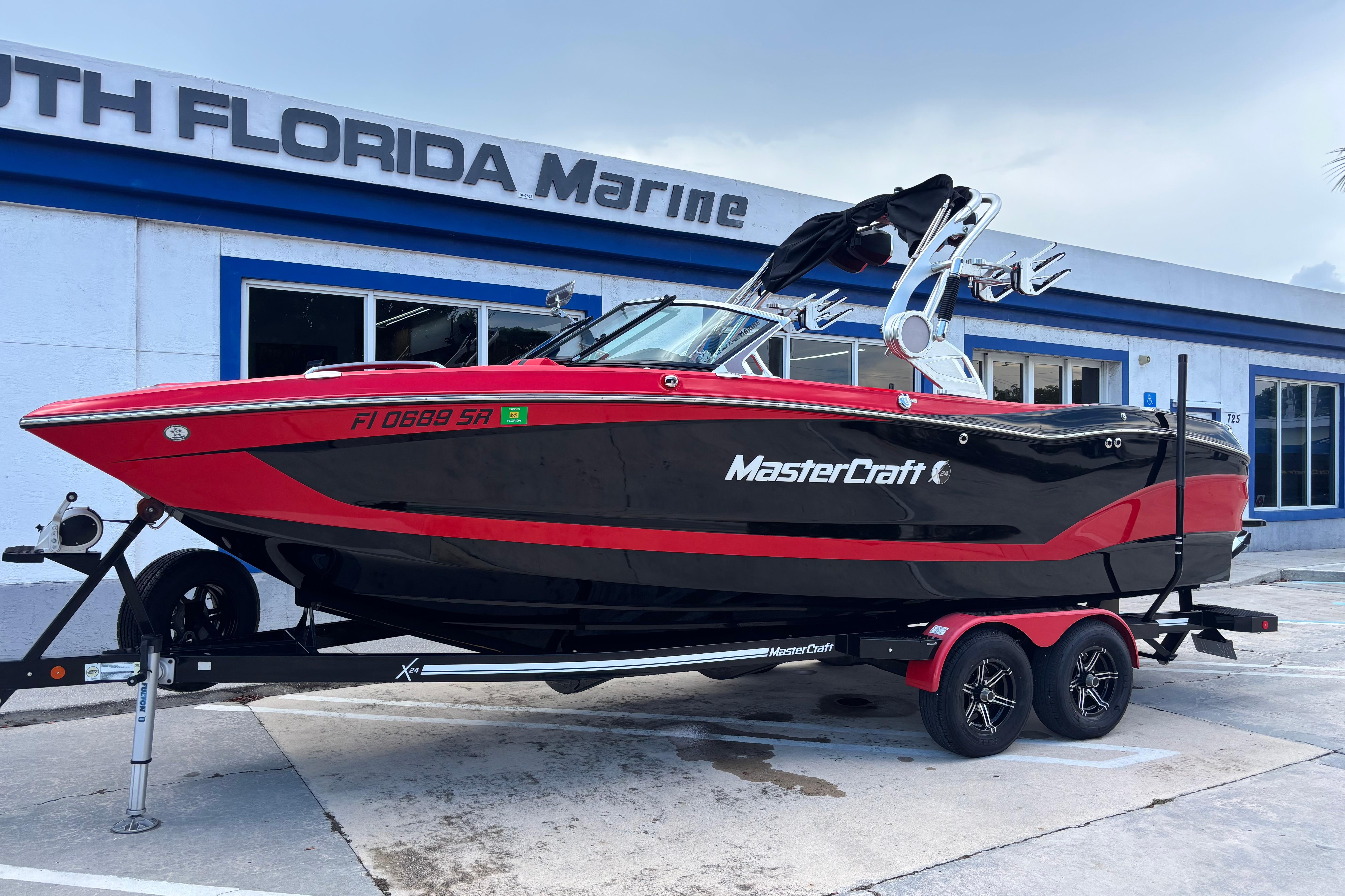 2020 MasterCraft X24 boat in red and black at South Florida Marine dealership.