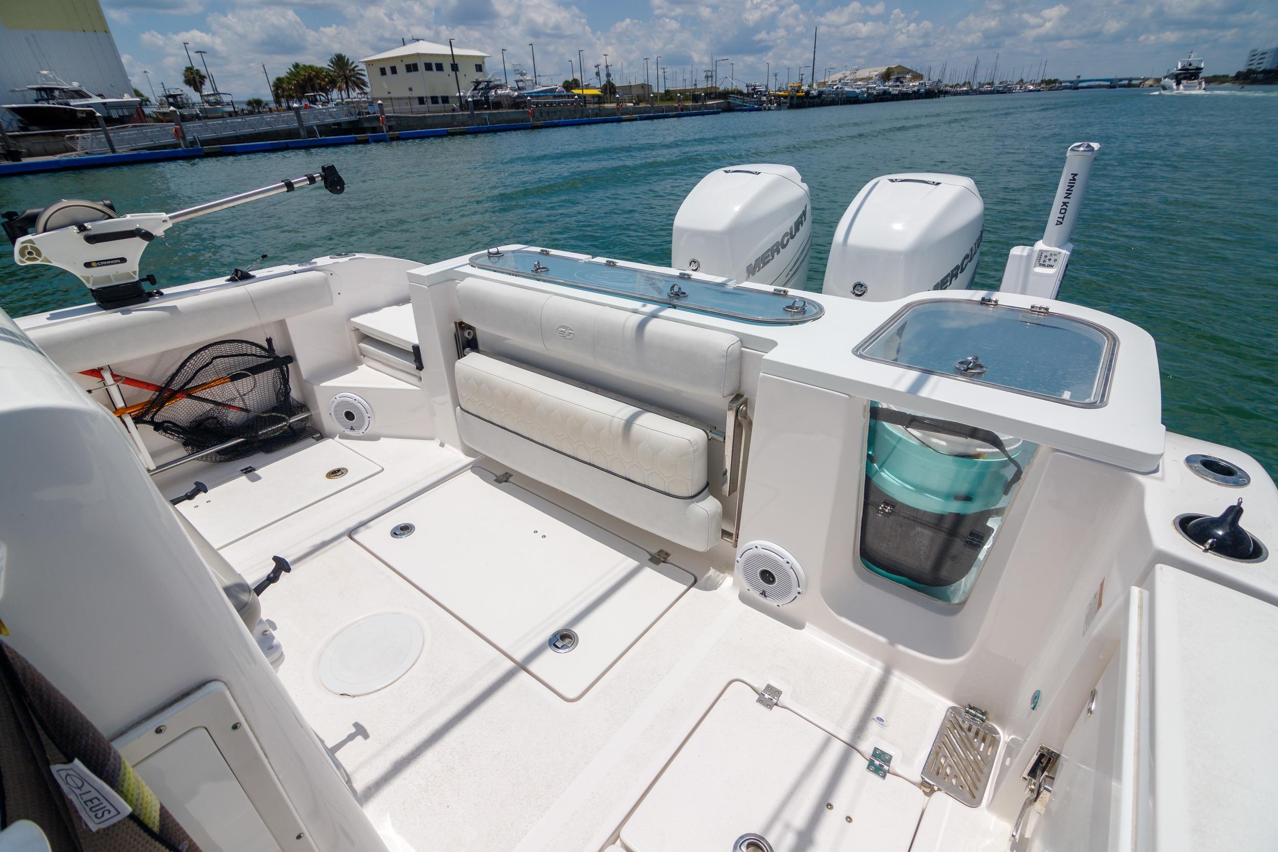 2021 Sea Fox 328 Commander boat deck with fishing gear and twin Mercury engines.