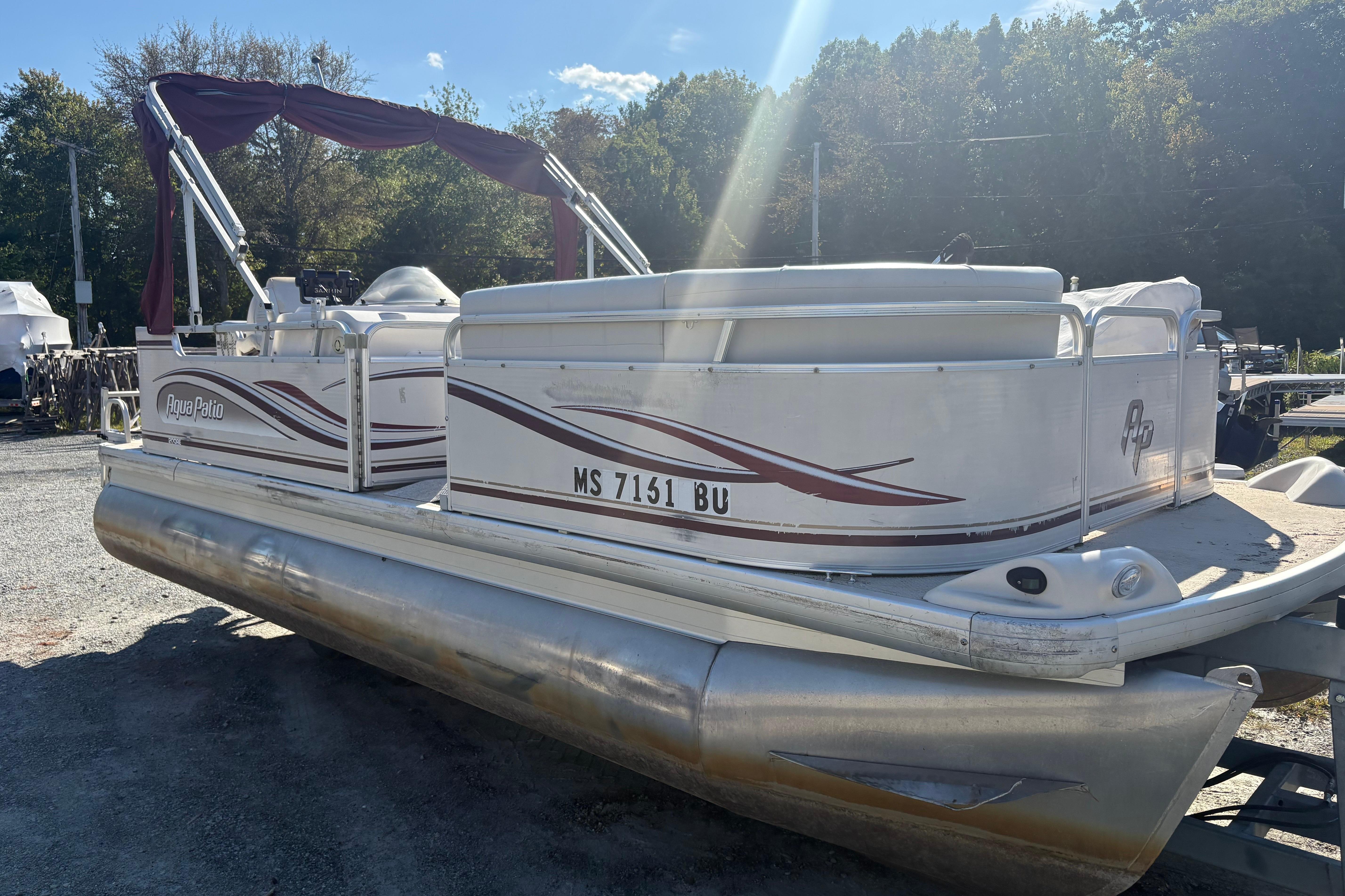 2003 Aqua Patio 200RE pontoon boat with maroon accents, parked outdoors.