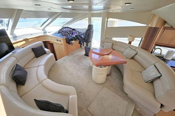 Luxurious interior of a 2005 Sunseeker Manhattan 66 yacht with plush seating and helm.