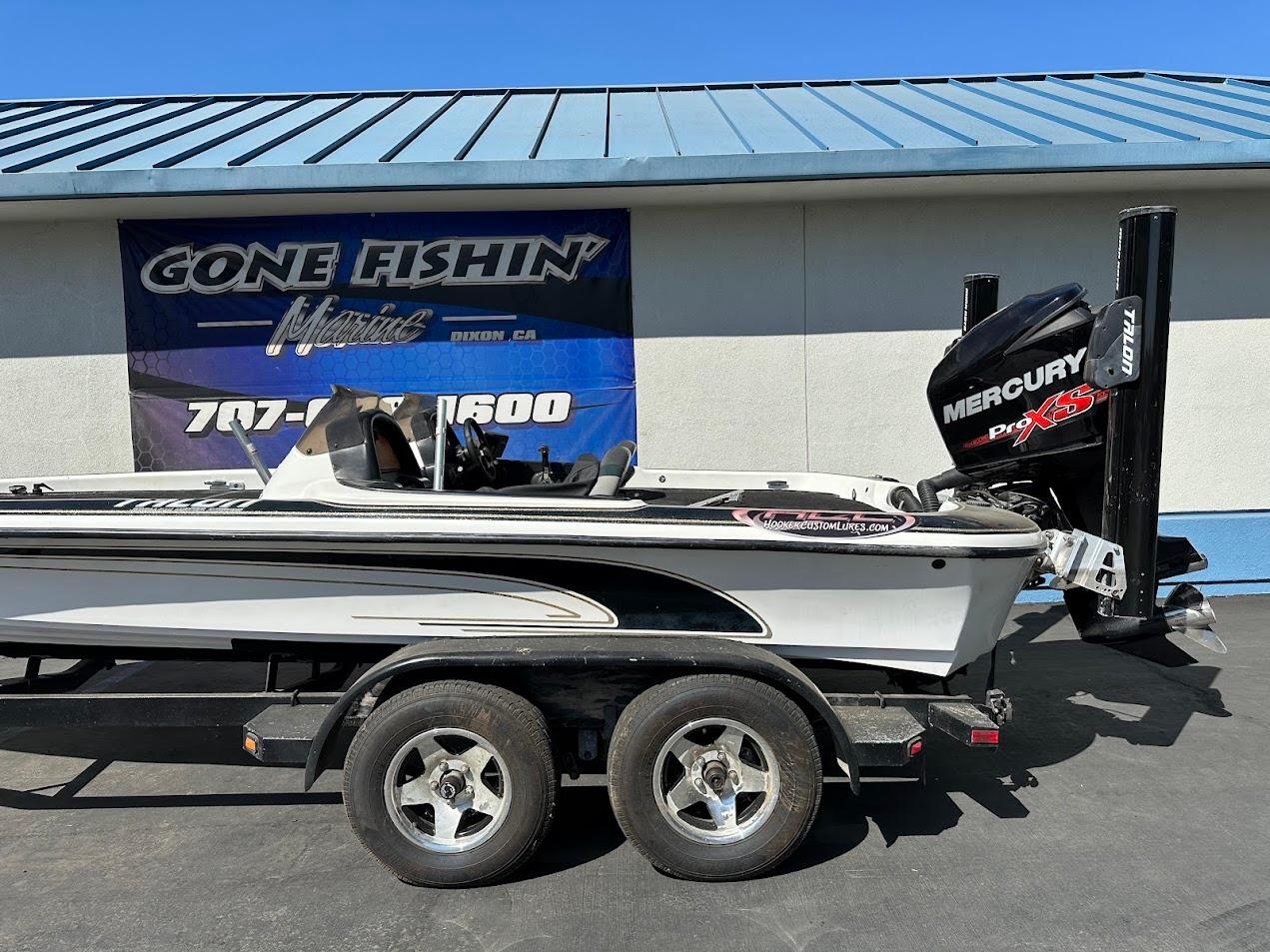 1999 Fisher 21 FX DC boat with Mercury Pro XS engine on trailer.