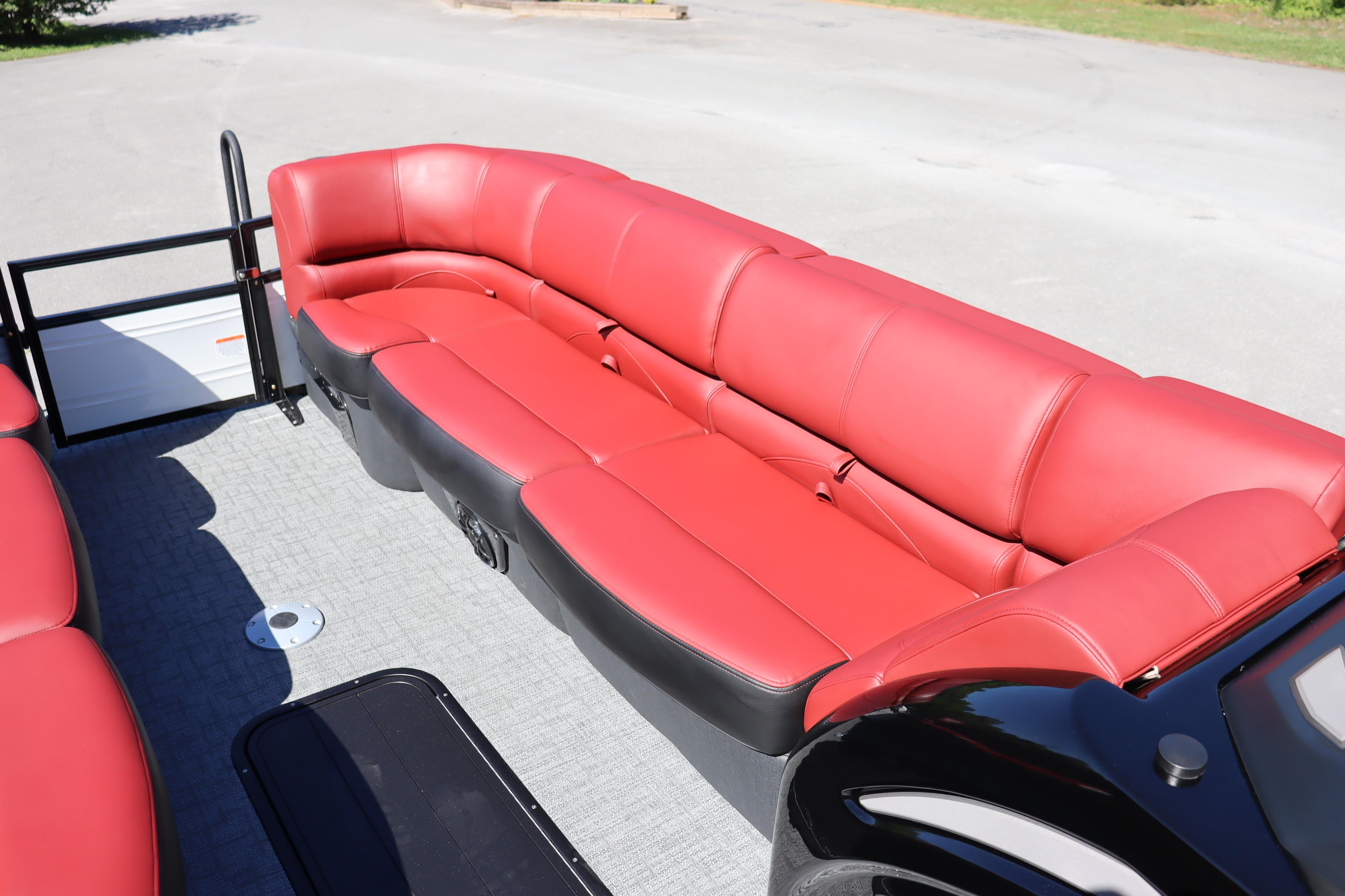 2026 Regency 250 DL boat with luxurious red seating on a sunny day.