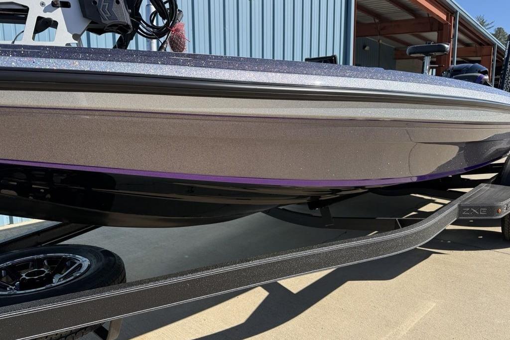 2026 Skeeter ZXE21 boat on trailer, metallic finish, parked near blue building.