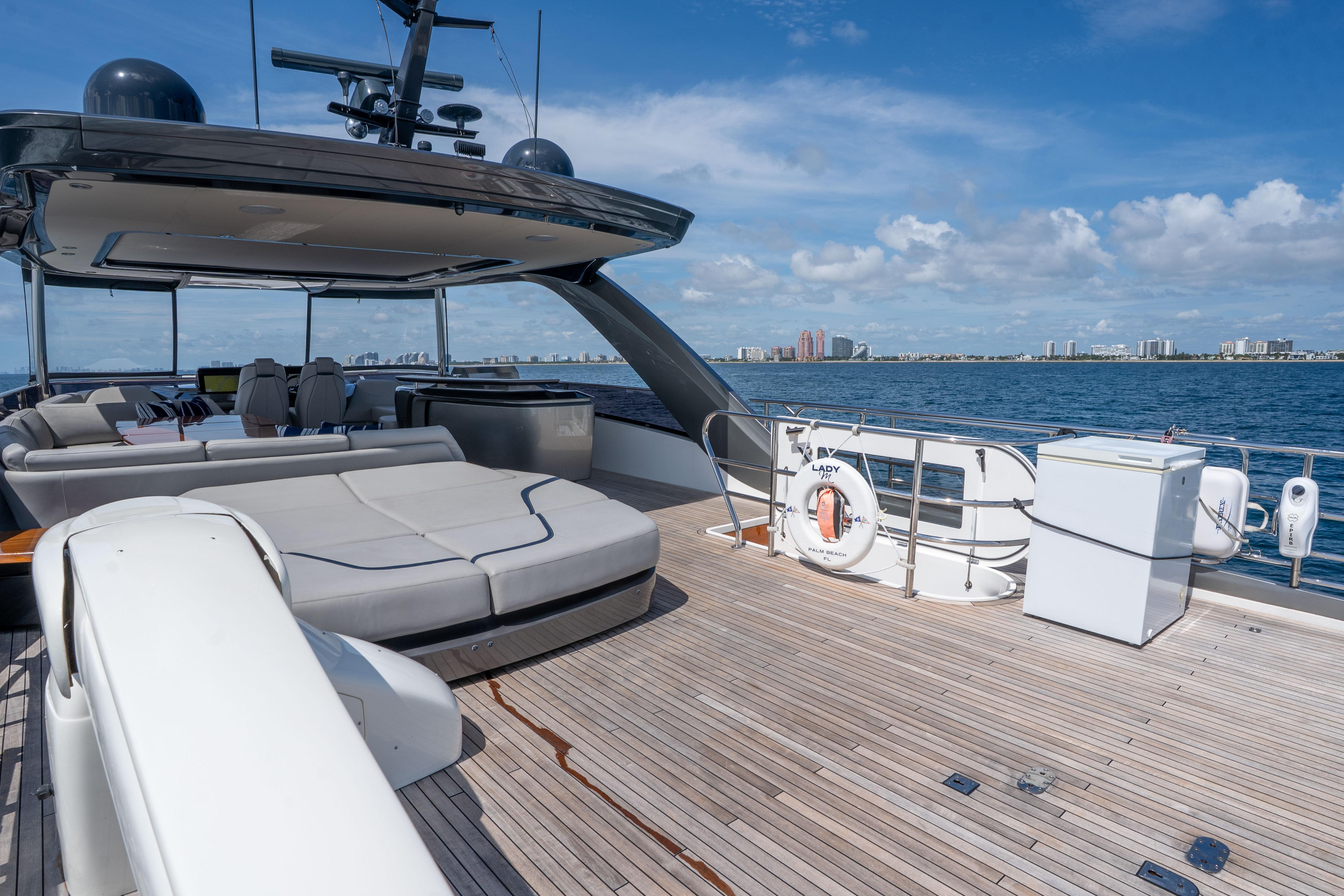 Luxurious 2020 Princess Y85 yacht deck with seating, ocean view, and city skyline.