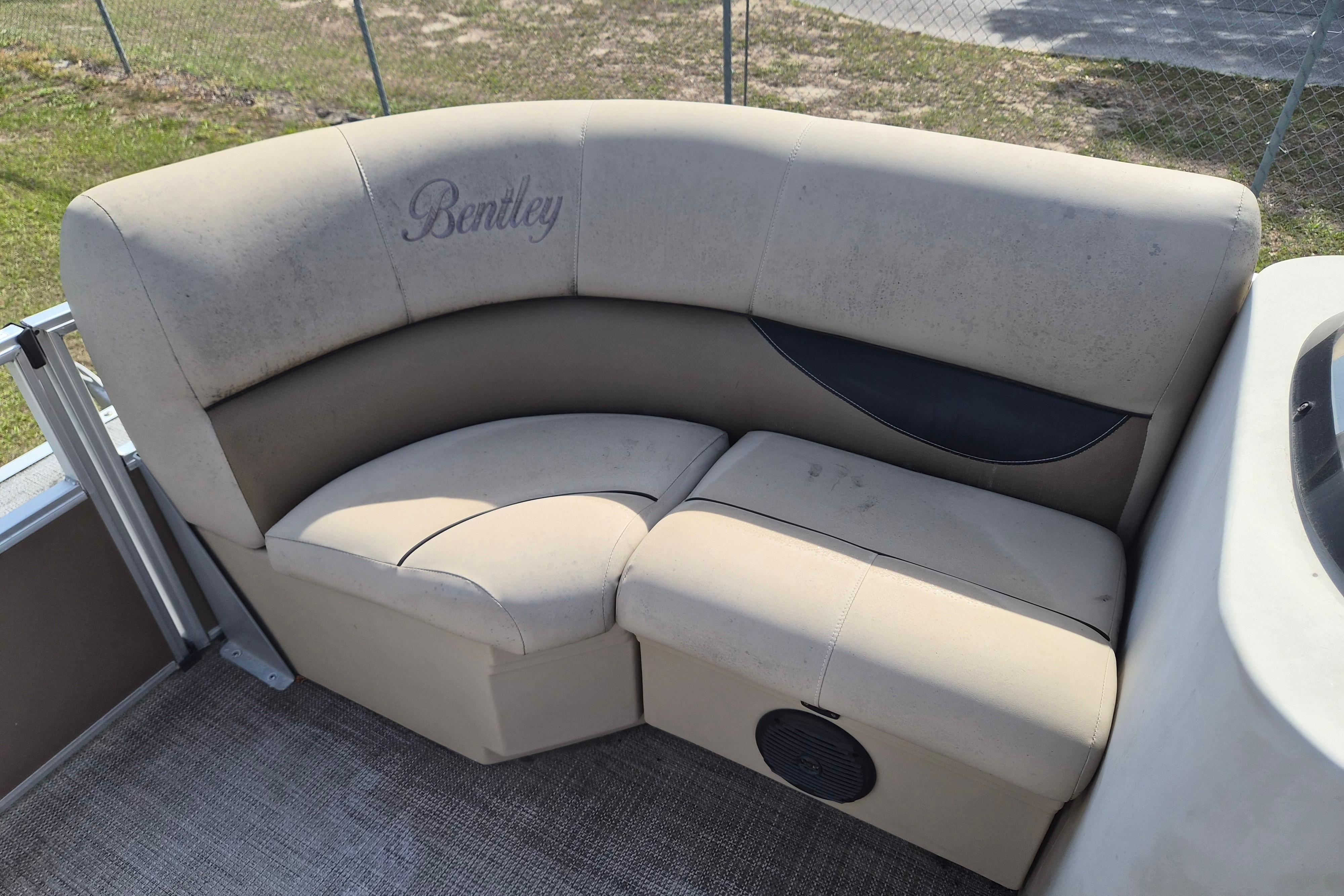 Bentley Pontoons 180 CRUISE 2004 boat seating with beige upholstery and logo.