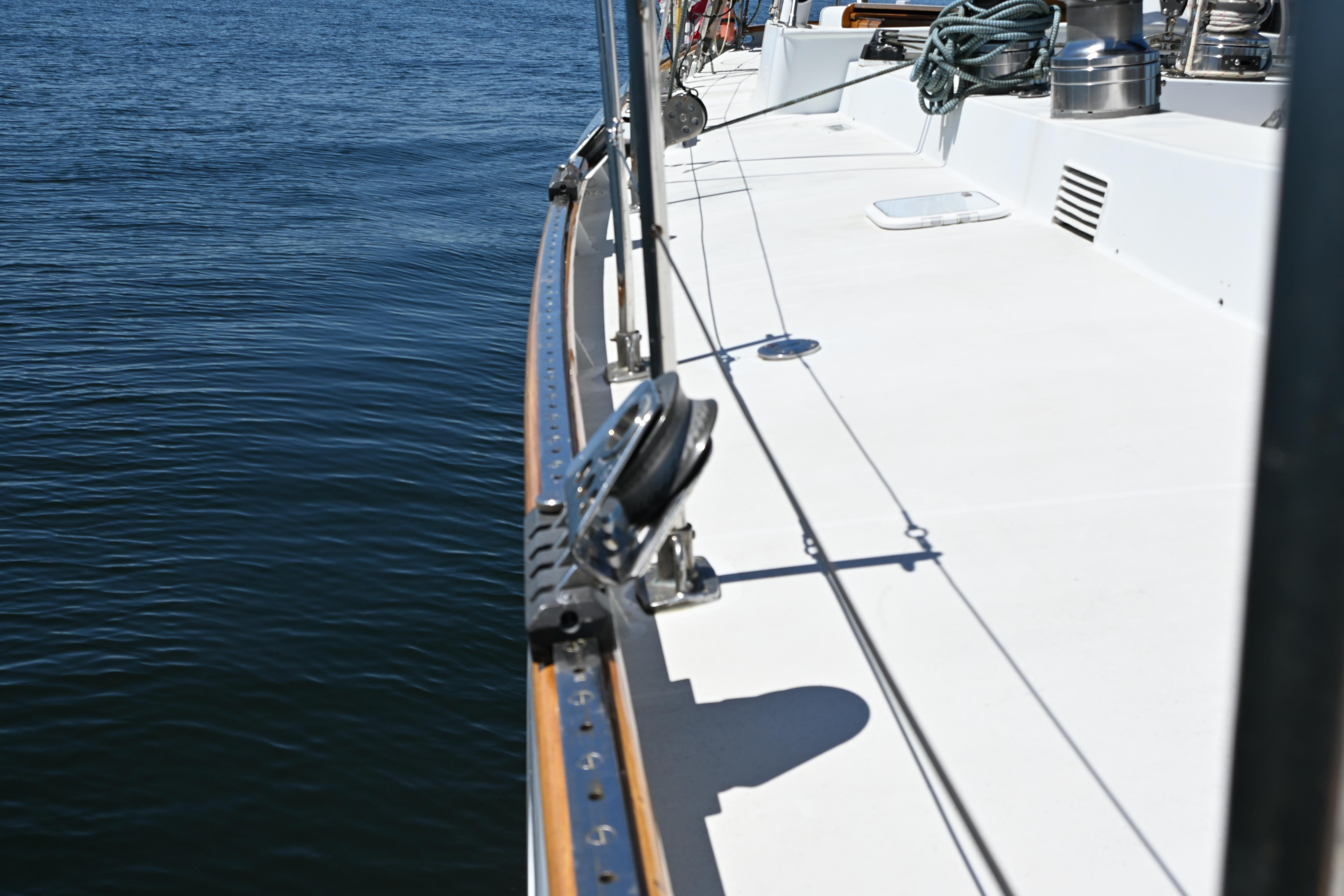 Deck view of a 1968 Abeking & Rasmussen Tripp 74 yacht on calm water.