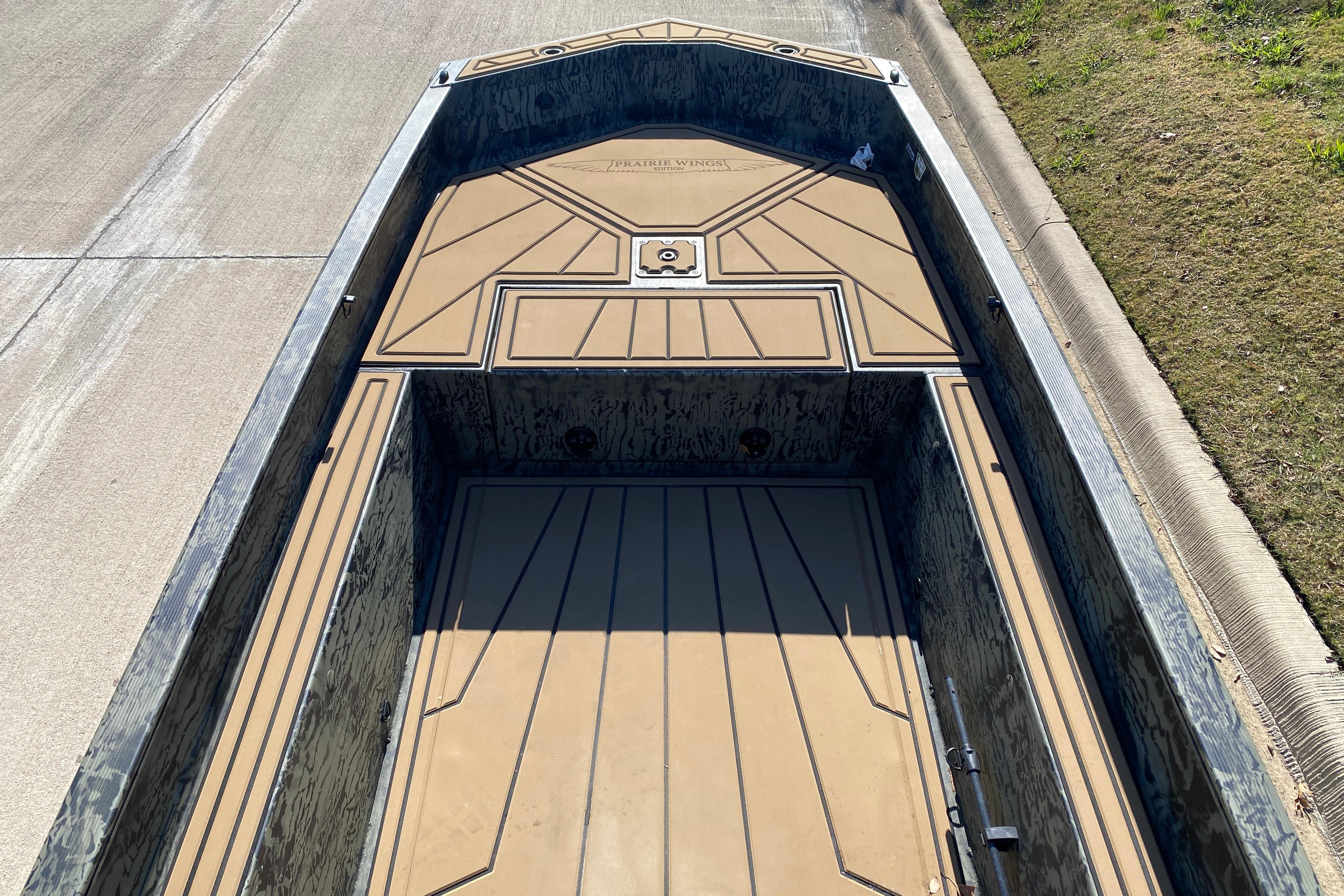 2026 Tracker Grizzly 1650 T Prairie Wings Edition boat interior, featuring a camo design.