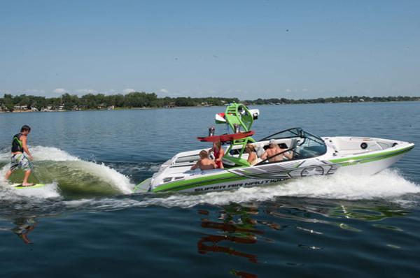 Manufacturer Provided Image: 2013 Nautique Super Air Nautique 230 towing a wakeboarder on a lake.