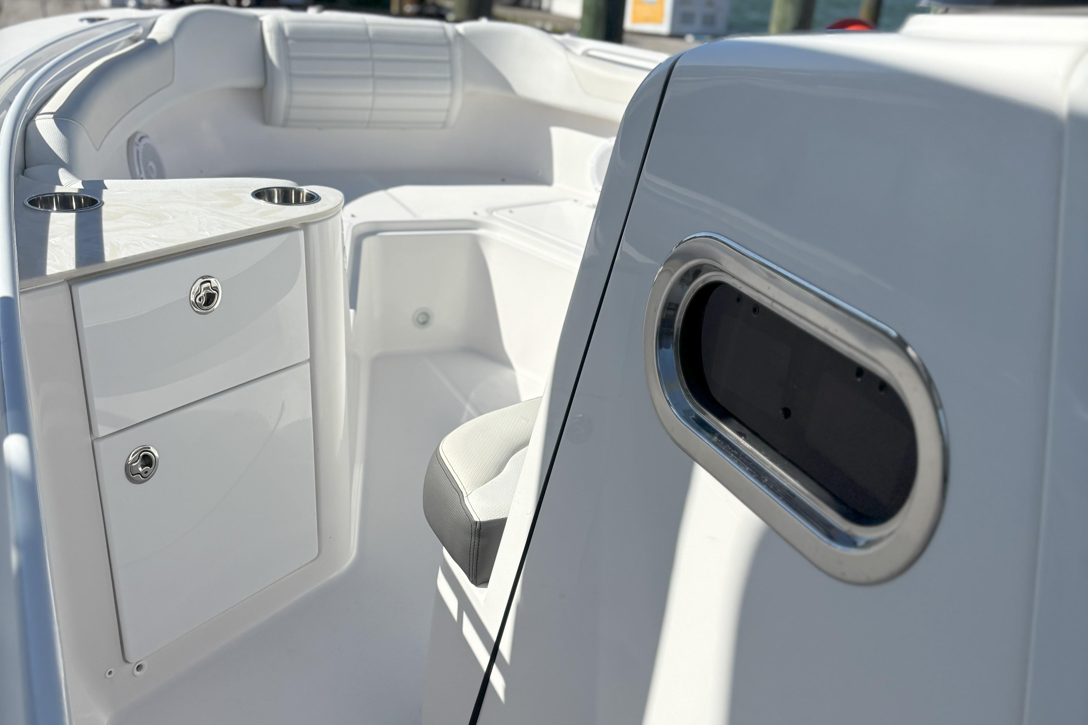 2024 Edgewater 262CC boat interior with storage compartments and seating.