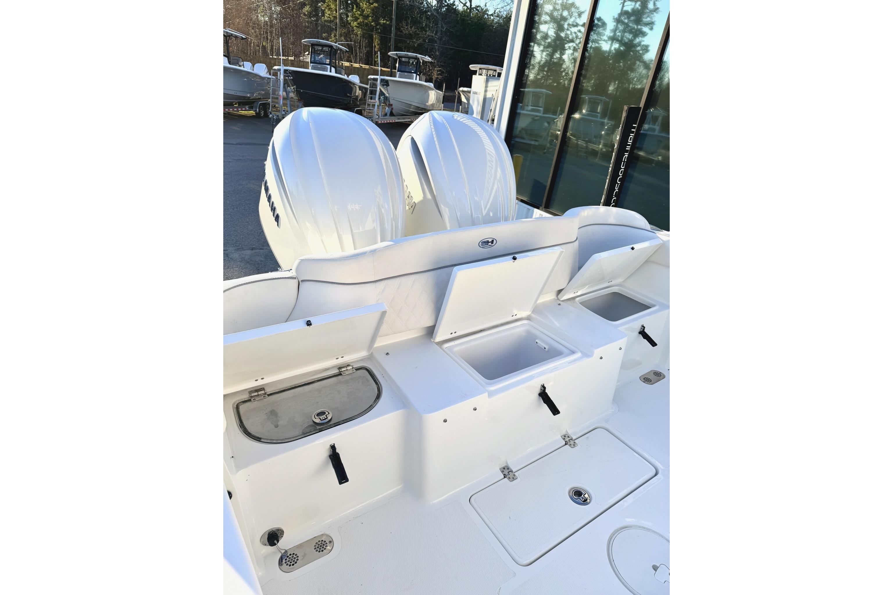 2026 Sea Hunt Ultra 275 Coffin Box boat with open storage compartments and dual engines.