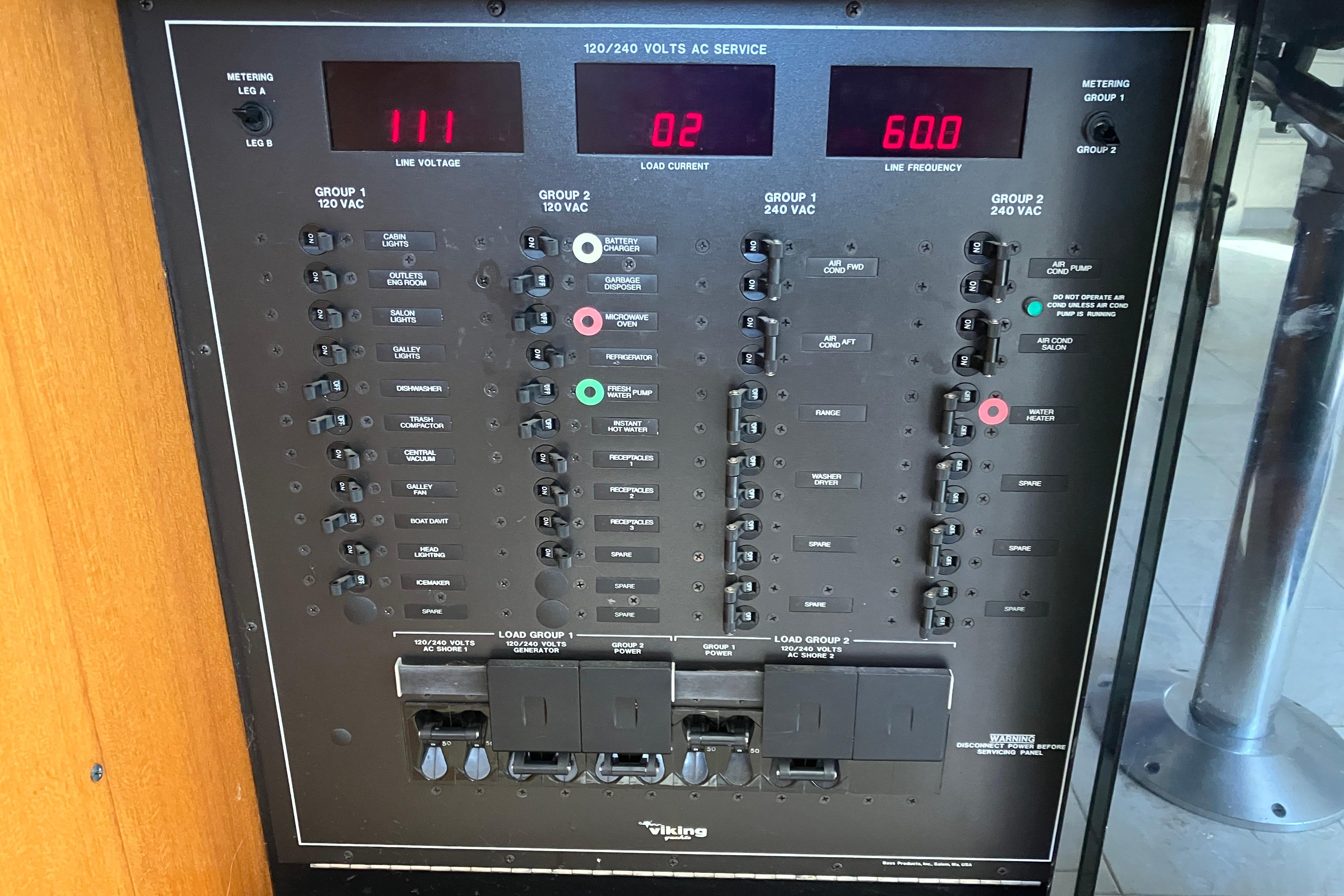 Electrical panel of a 1995 Viking 50 Motor Yacht, displaying line voltage and current.