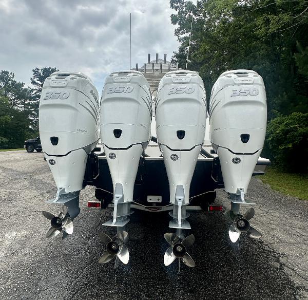 2008 SeaVee 390B boat with four powerful outboard engines, parked outdoors.