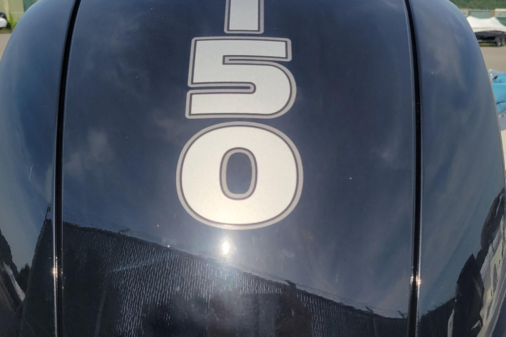 Close-up of a 2024 Tahoe 200 S outboard motor with "150" marking.