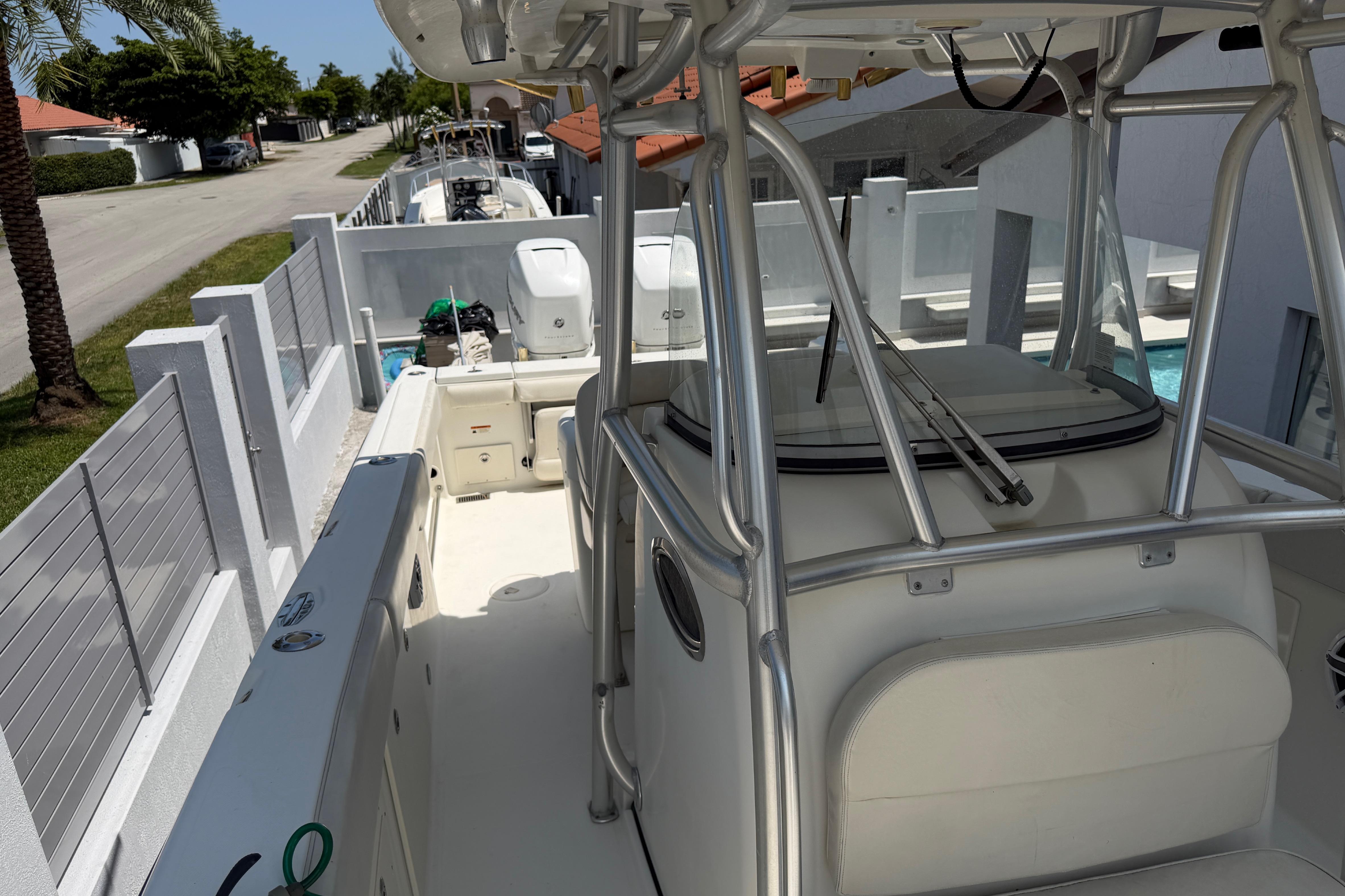 2008 Hydra-Sports Vector 2900 CC boat docked near a residential area.