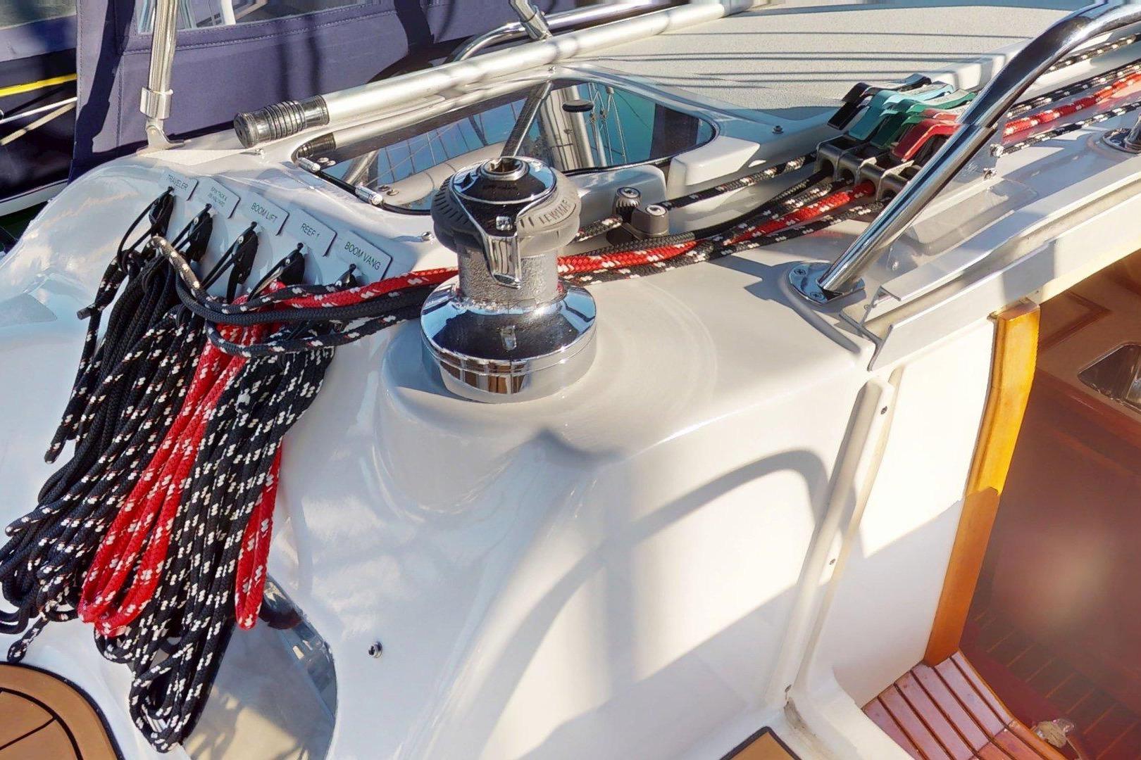 Deck of 1997 Hunter Legend 40.5 sailboat with winch and colorful ropes.