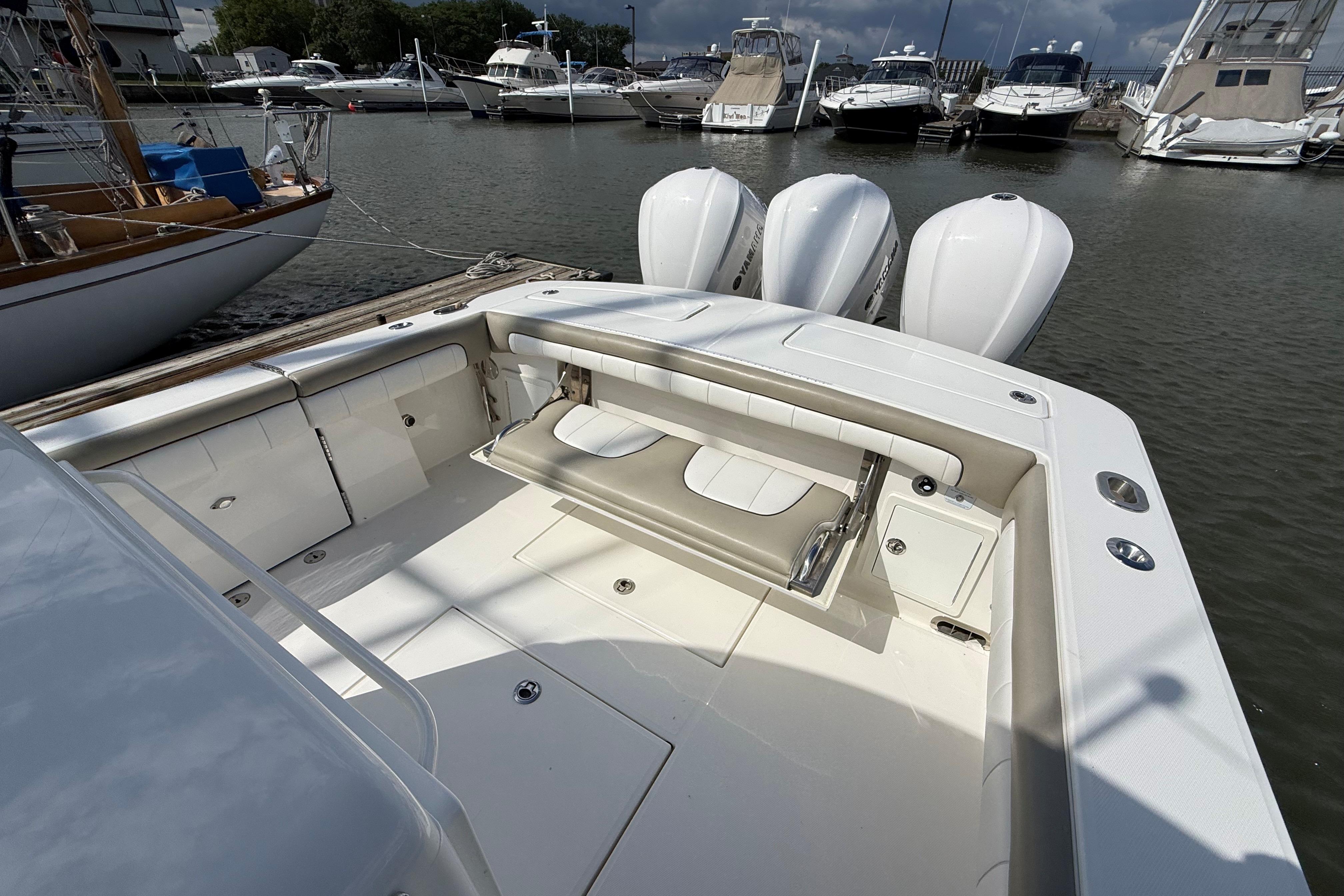 2019 Regulator 34SS boat with triple engines docked at marina.