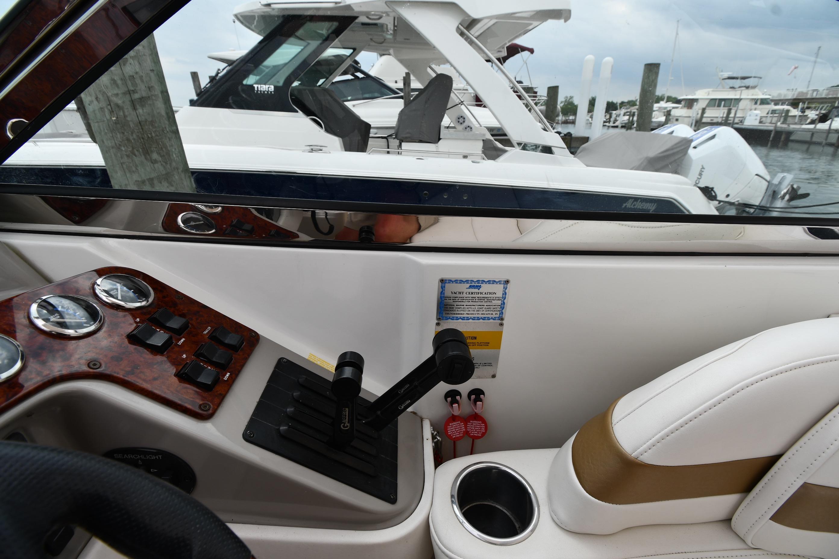 Interior view of a 2004 Formula 330 Sun Sport boat cockpit with controls and seating.