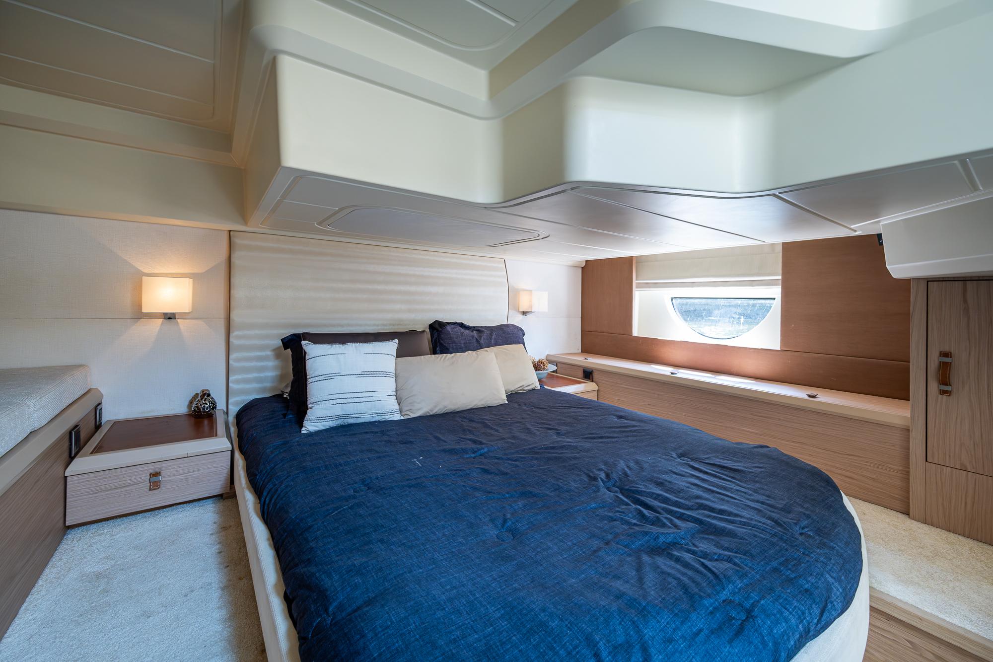 Luxurious bedroom interior of 2015 Beneteau Monte Carlo yacht with modern design.