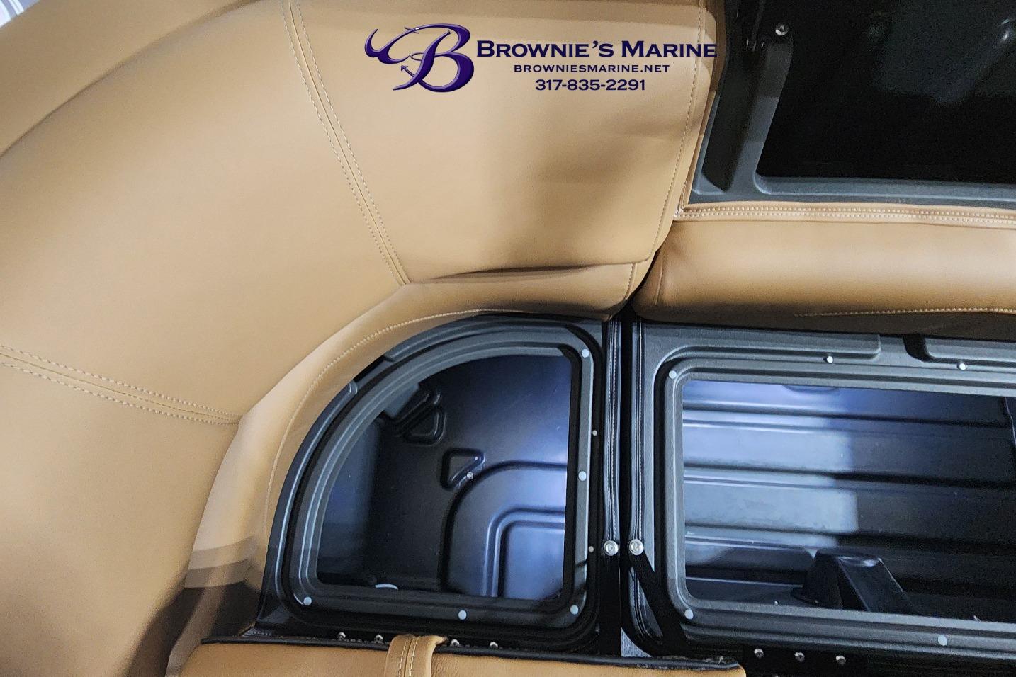 Brown leather seating and storage compartments in 2026 Regency 250 DL boat interior.