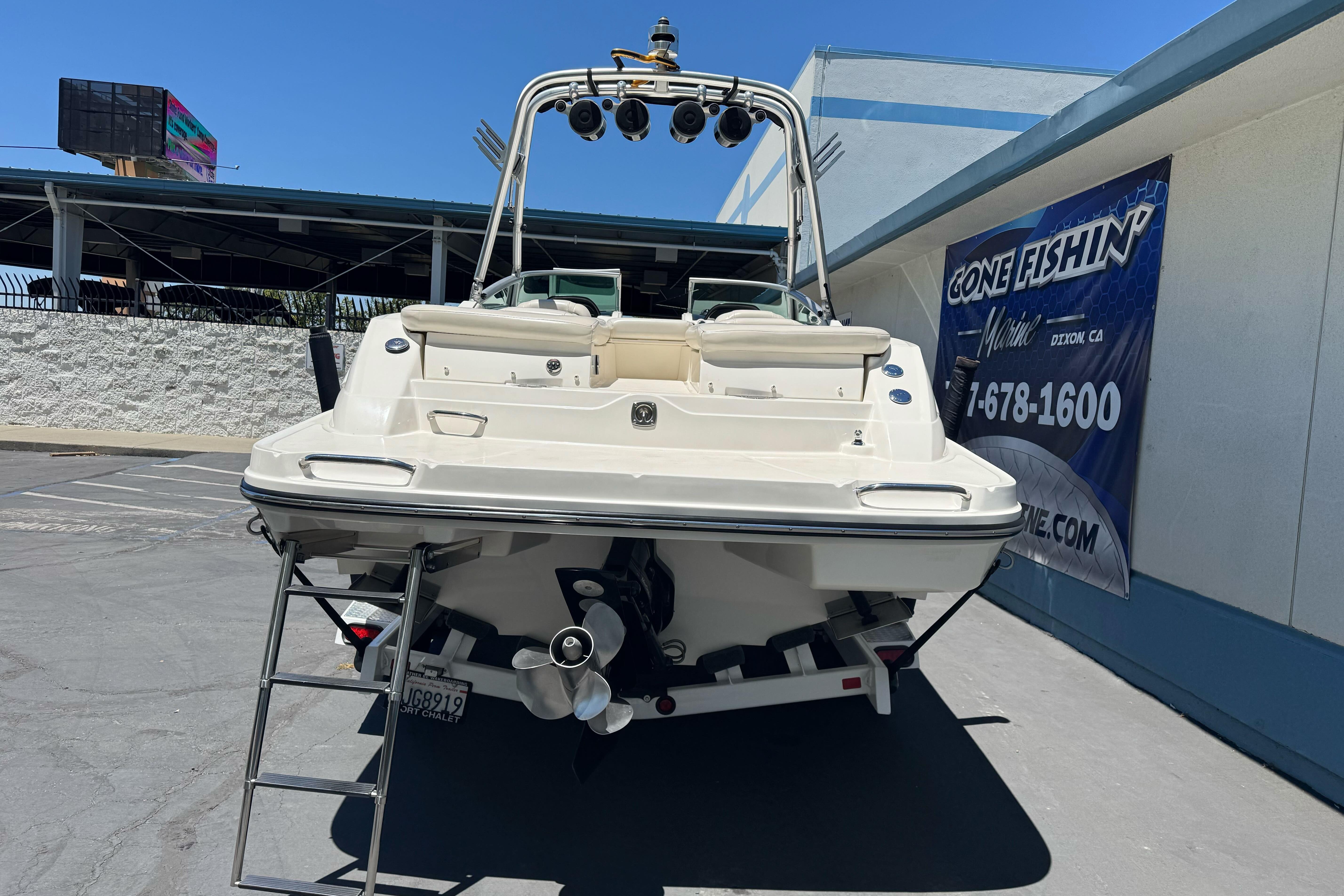 2007 Sea Ray SLX 250 boat parked at a marina with a visible ladder.