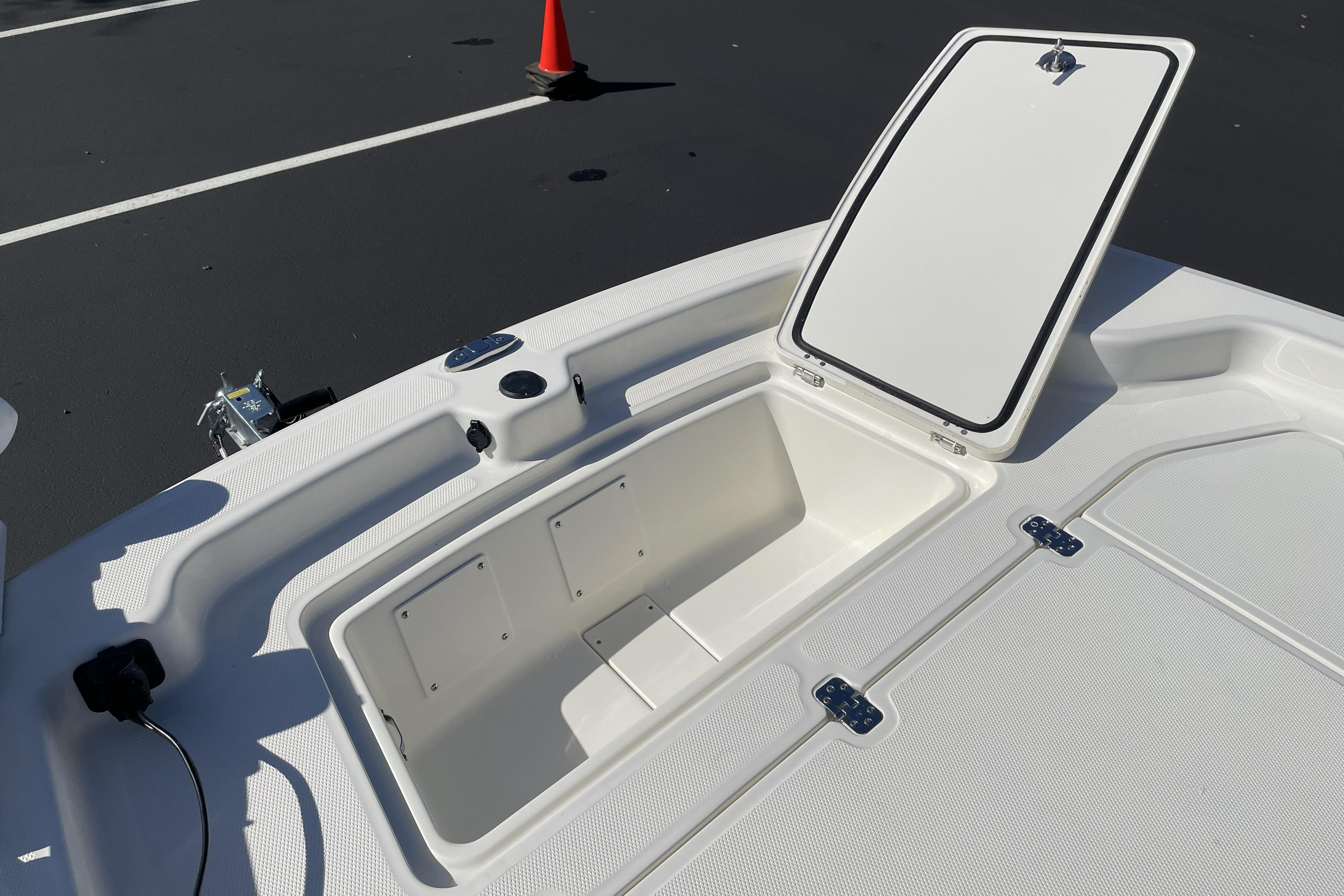 Open storage compartment on 2026 Mako Pro Skiff 19 CC boat deck.