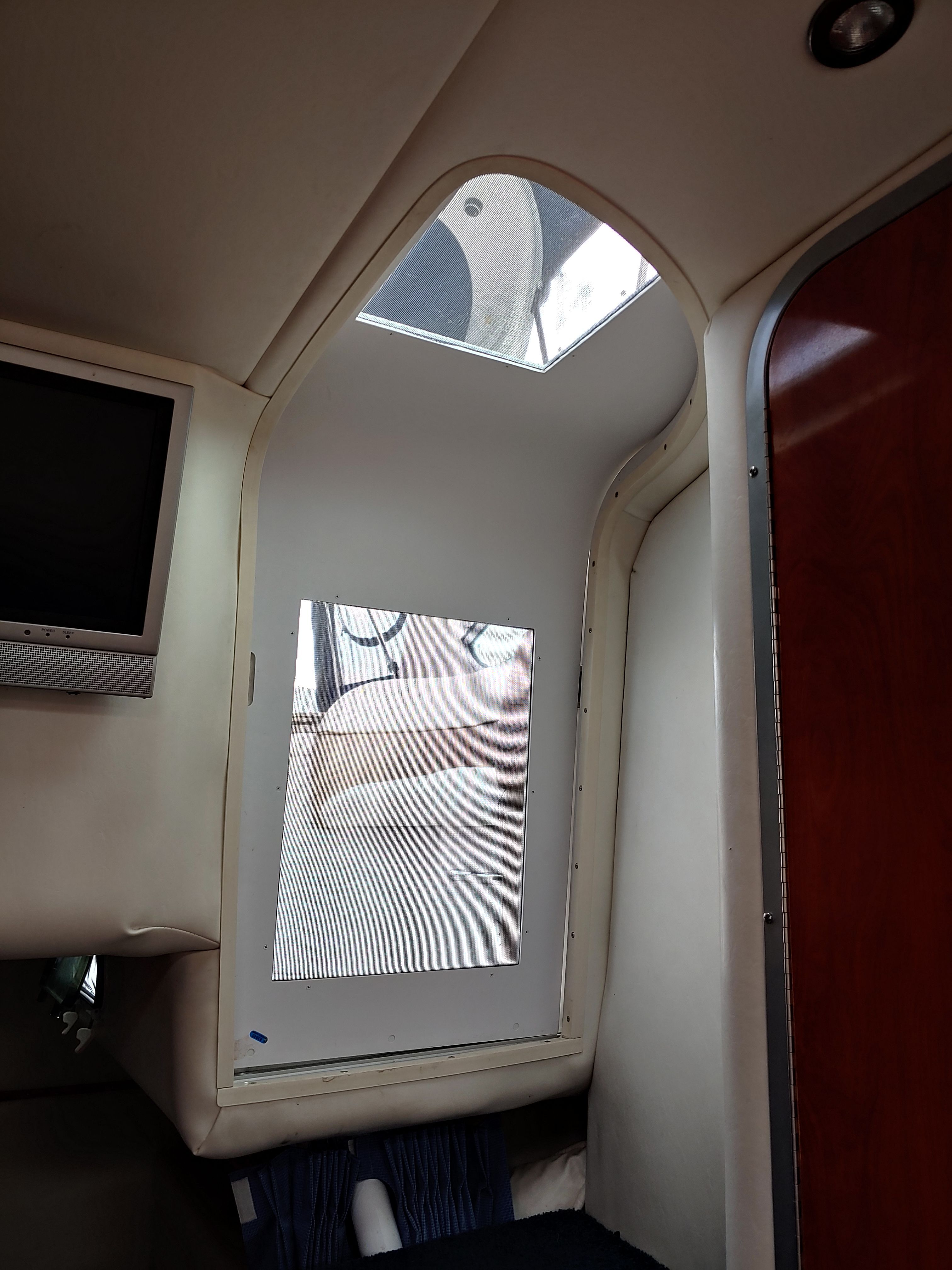 Interior of a yacht with a window and television.