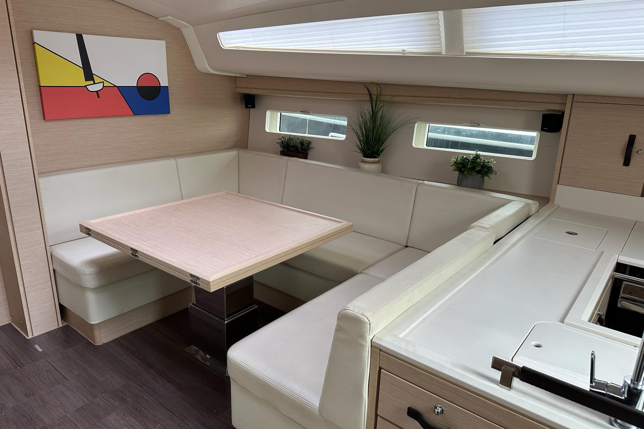 Modern interior of 2018 Jeanneau 51 yacht with sleek dining area and contemporary decor.