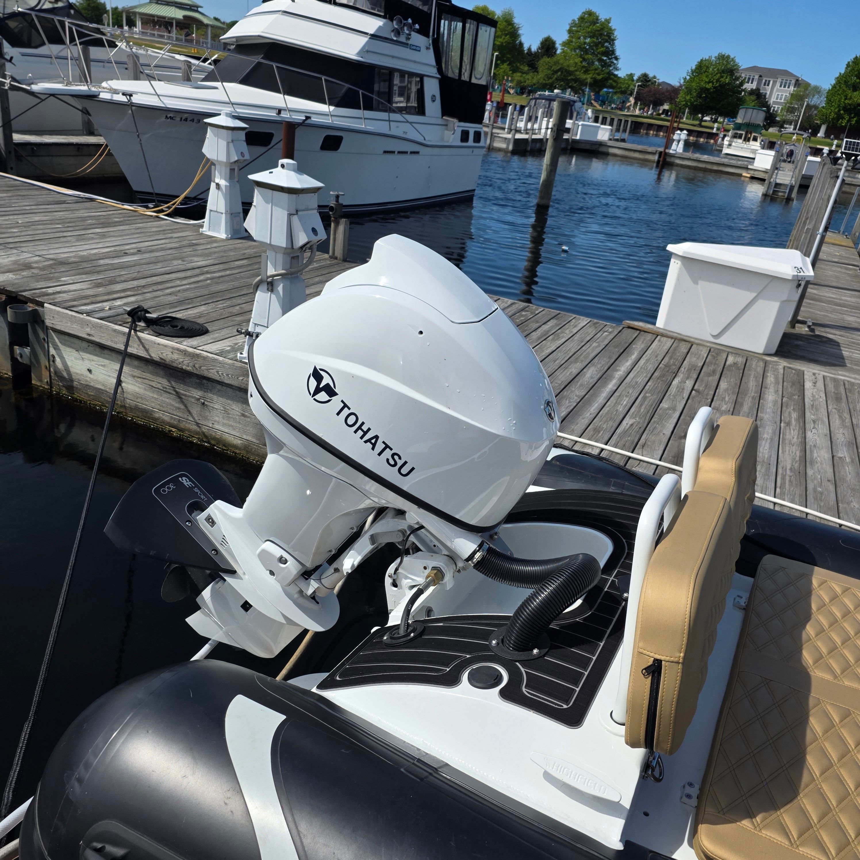 2024 Highfield Sport 390 with Tohatsu engine at dock.