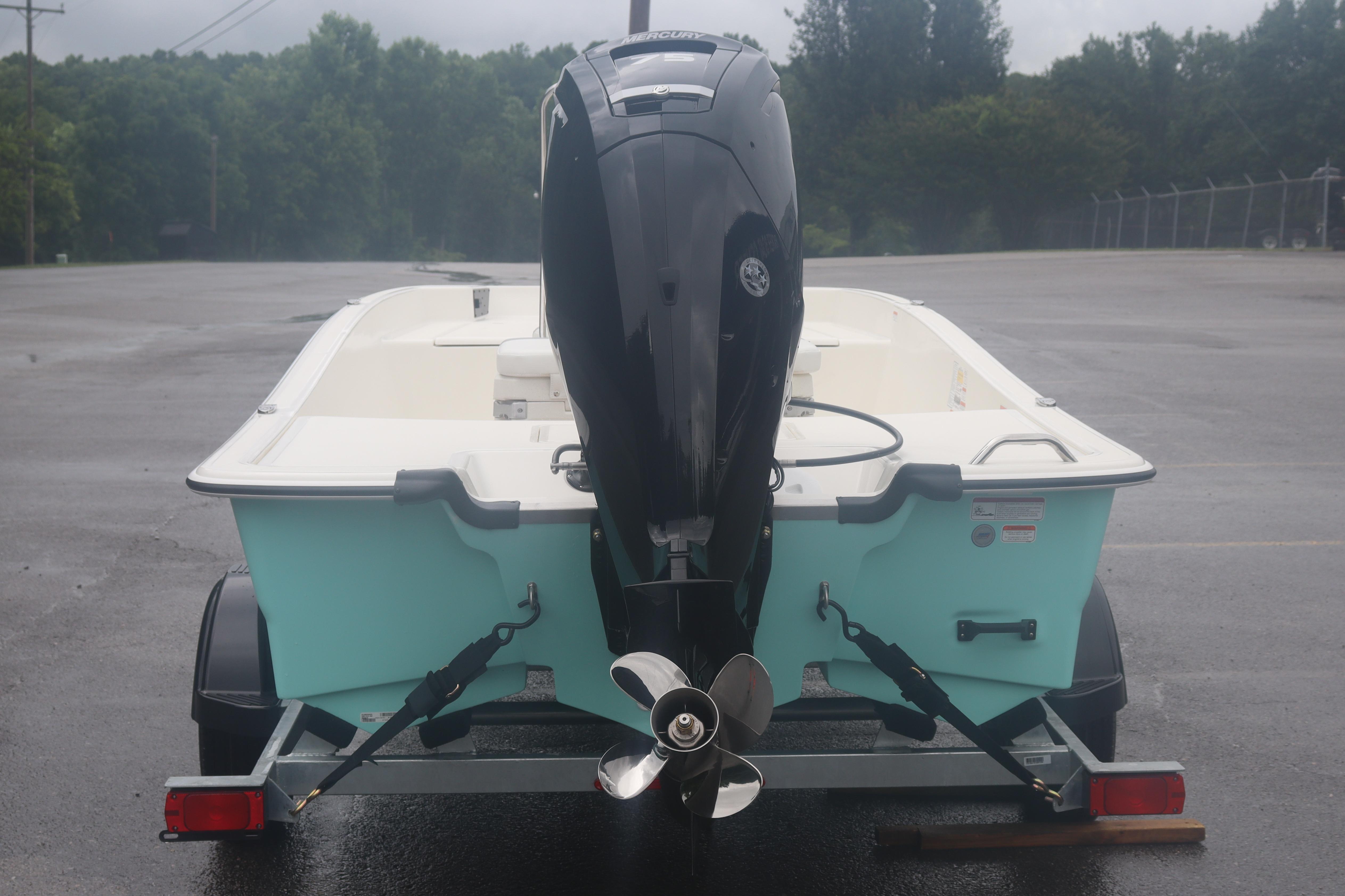 2026 Mako Pro Skiff 17 CC on trailer, rear view with outboard motor.