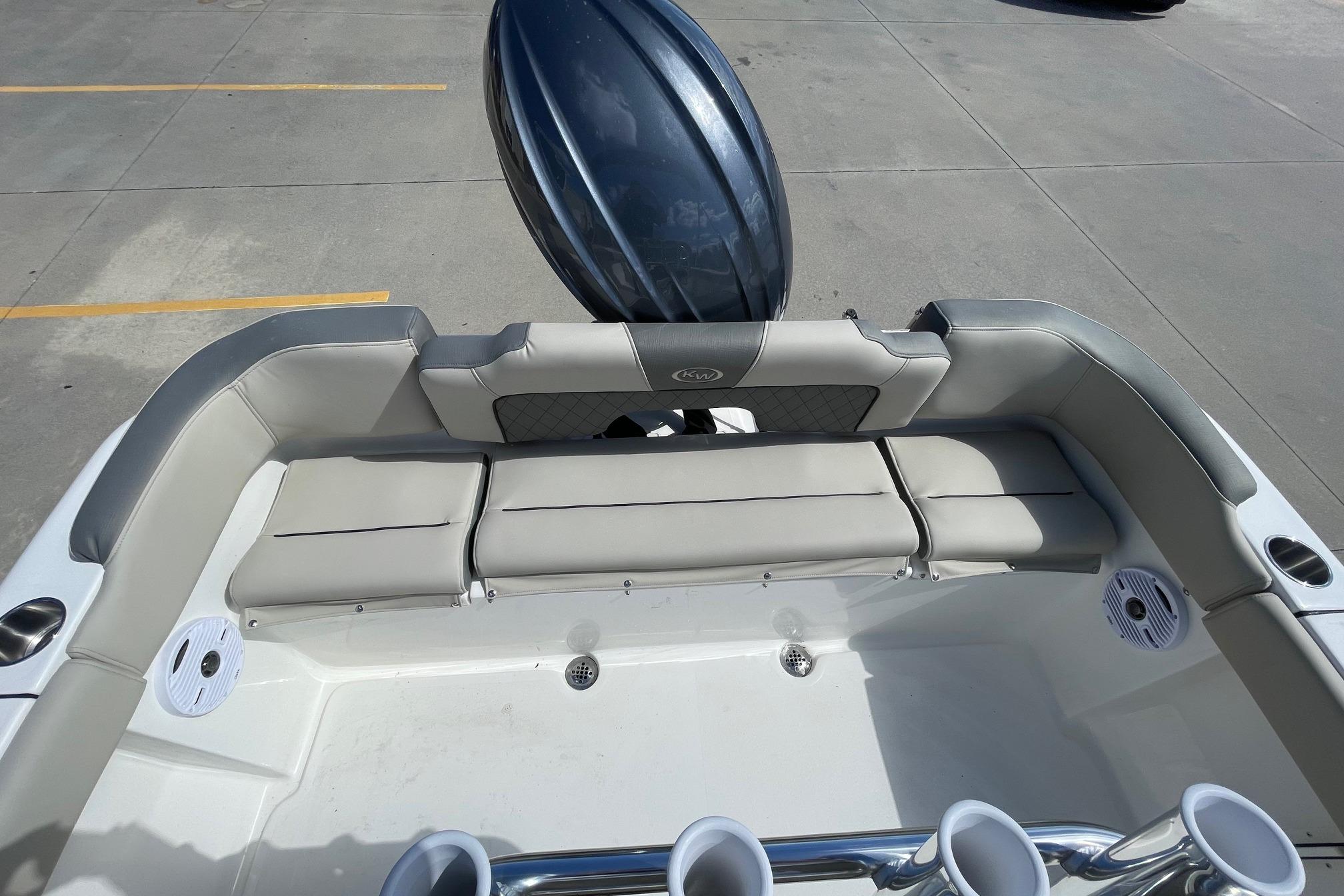 2026 Key West 203 FS boat interior with cushioned seating and cup holders.