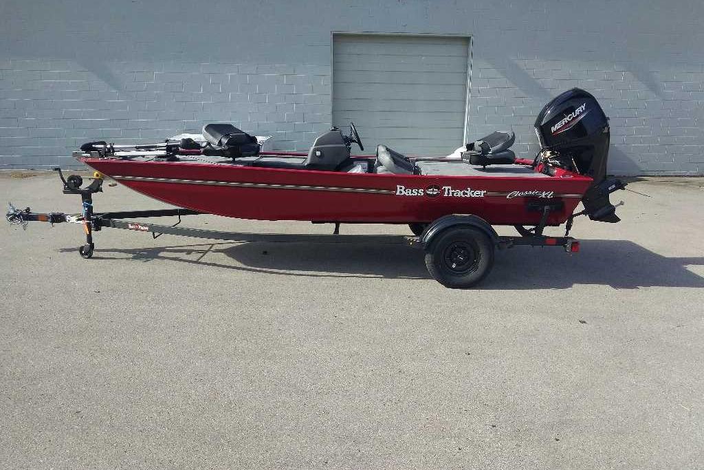 2026 Tracker Bass Tracker Classic XL boat on trailer, red exterior, parked outdoors.