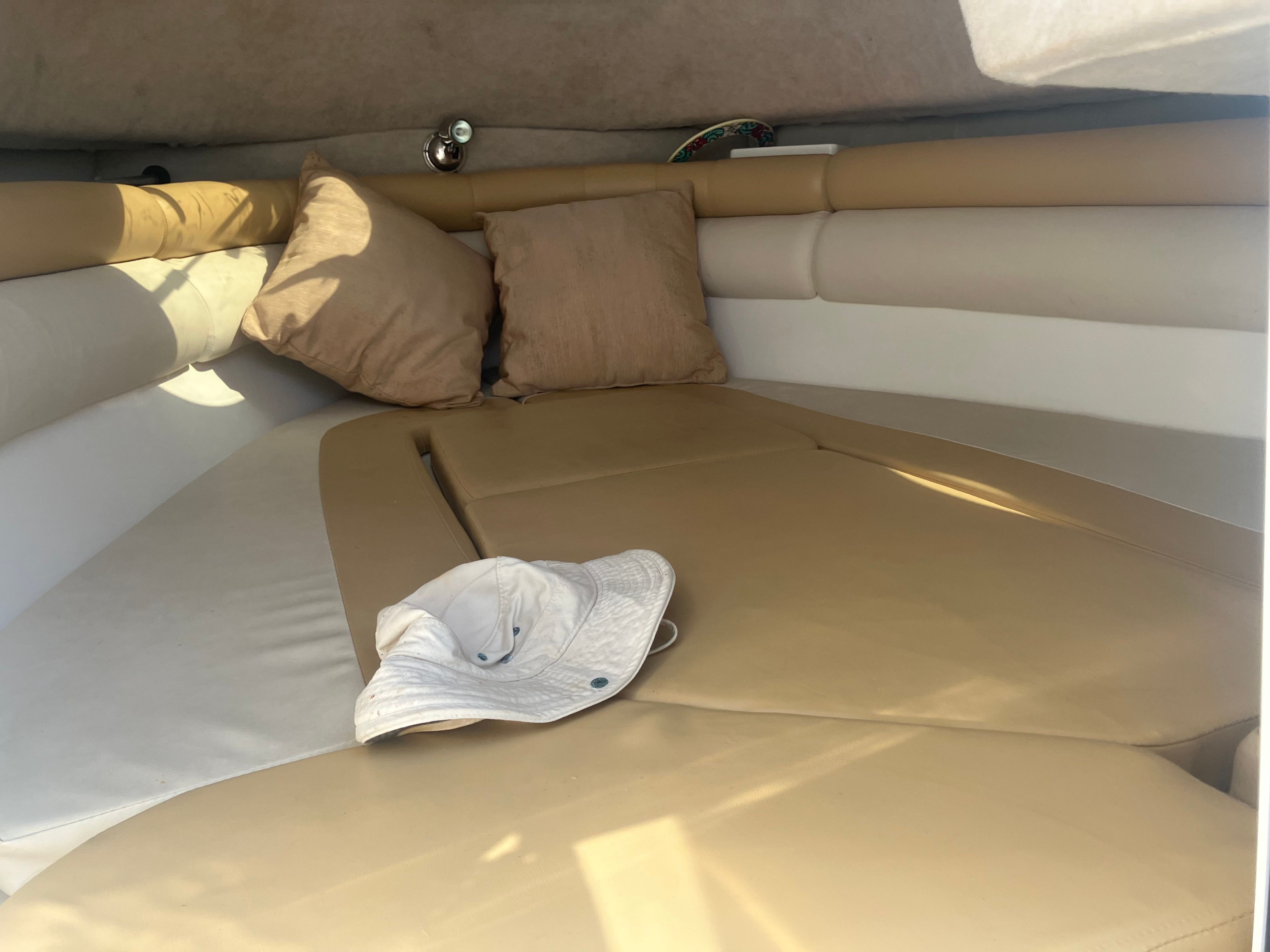 Interior of a 2010 Custom 216wa Pro boat with cushions and hat.